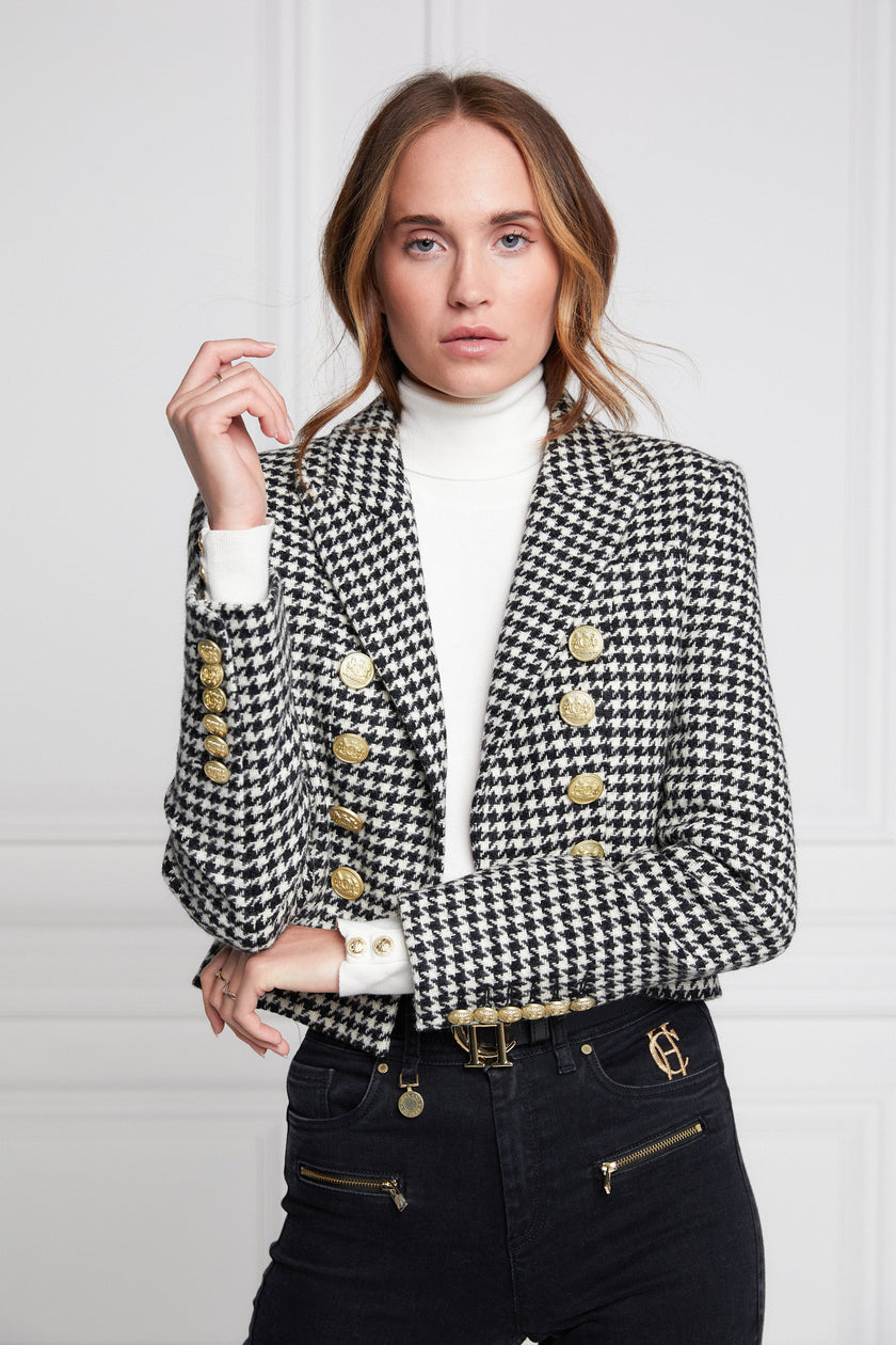 British made tailored cropped jacket in black and white houndstooth with welt pockets and gold button detail down the front and on sleeves