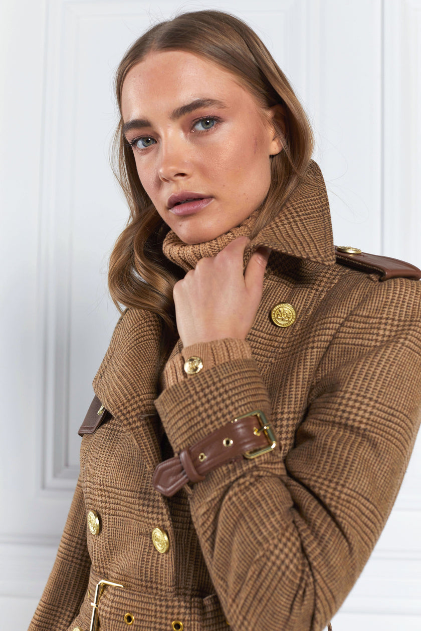 Detail of womens tawny light tan detailed with gold hardware knee length wool trench coat