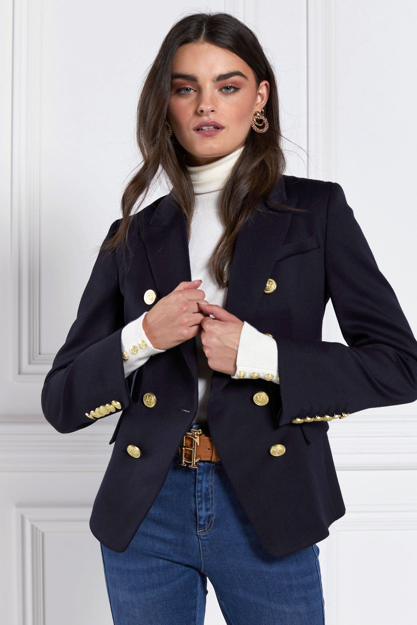 British made double breasted blazer that fastens with a single button hole to create a more form fitting silhouette with two pockets and gold button detailing this blazer is made from navy barathea fabric