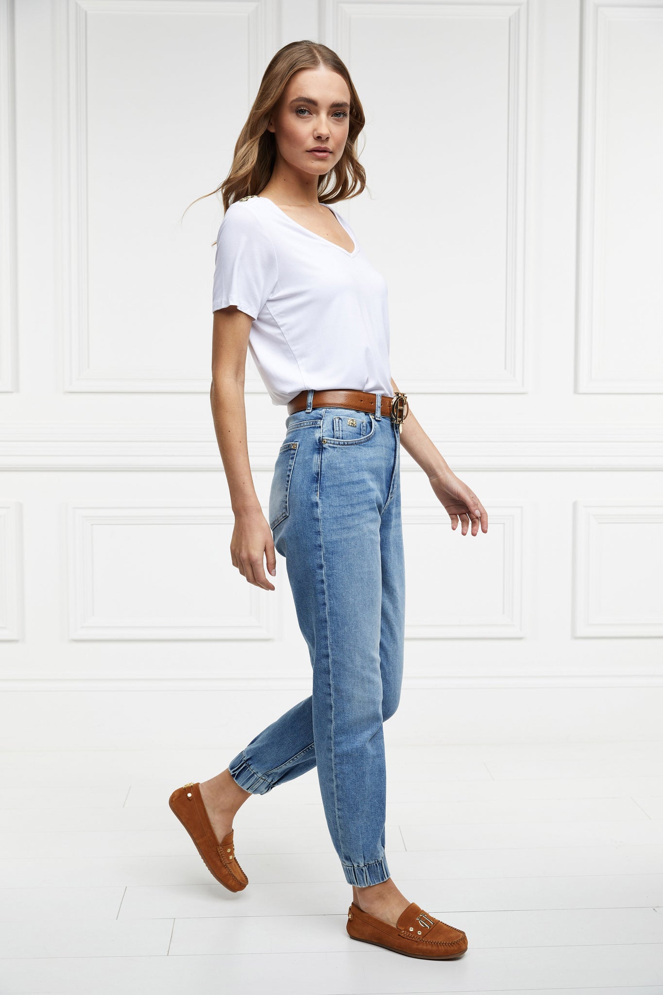 womens high rise blue denim jogger style slim fit jean with cuffed ankles and two open pockets to the front and back 