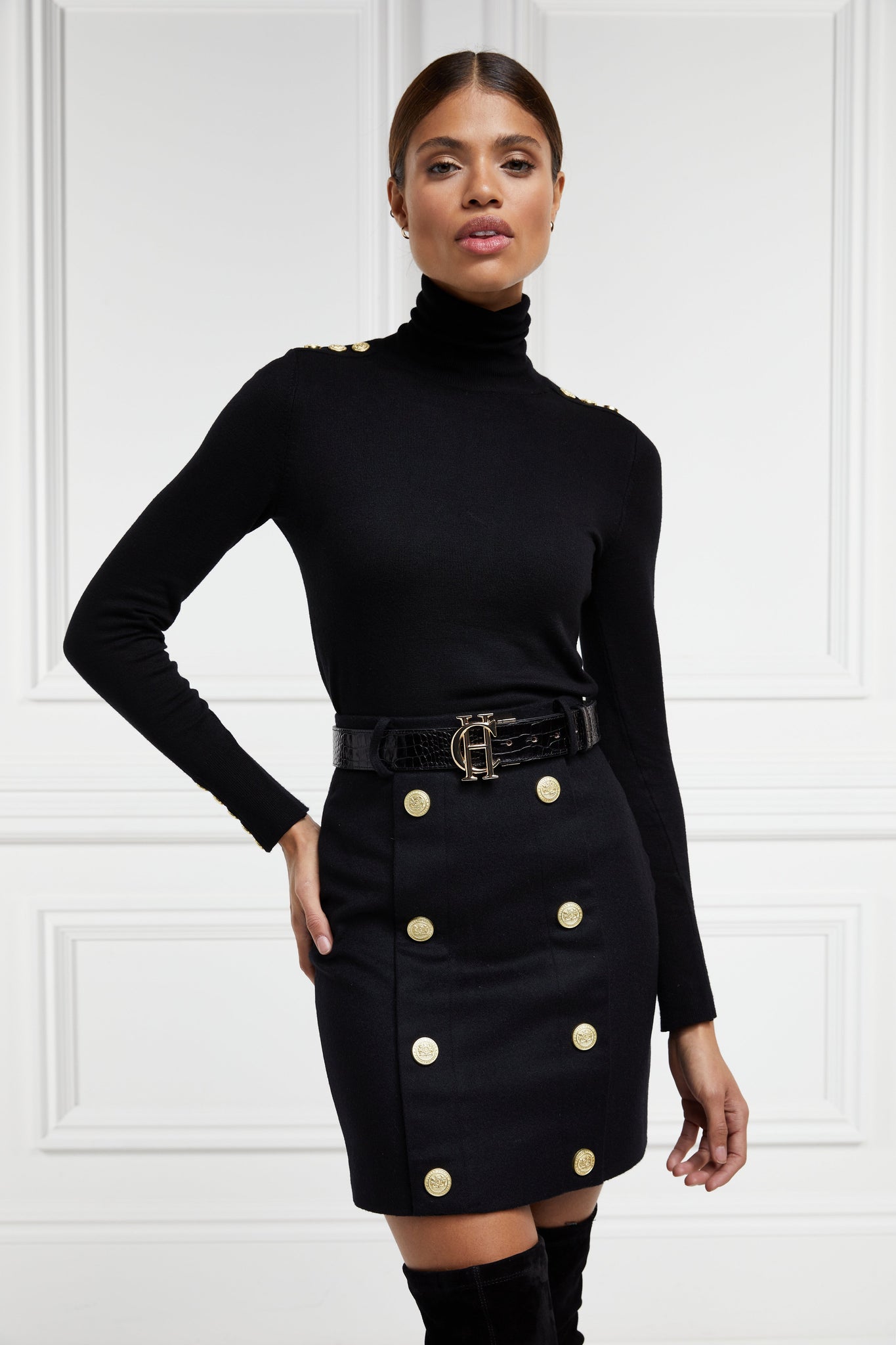 womens black wool pencil mini skirt with concealed zip fastening on centre back and gold rivets down front