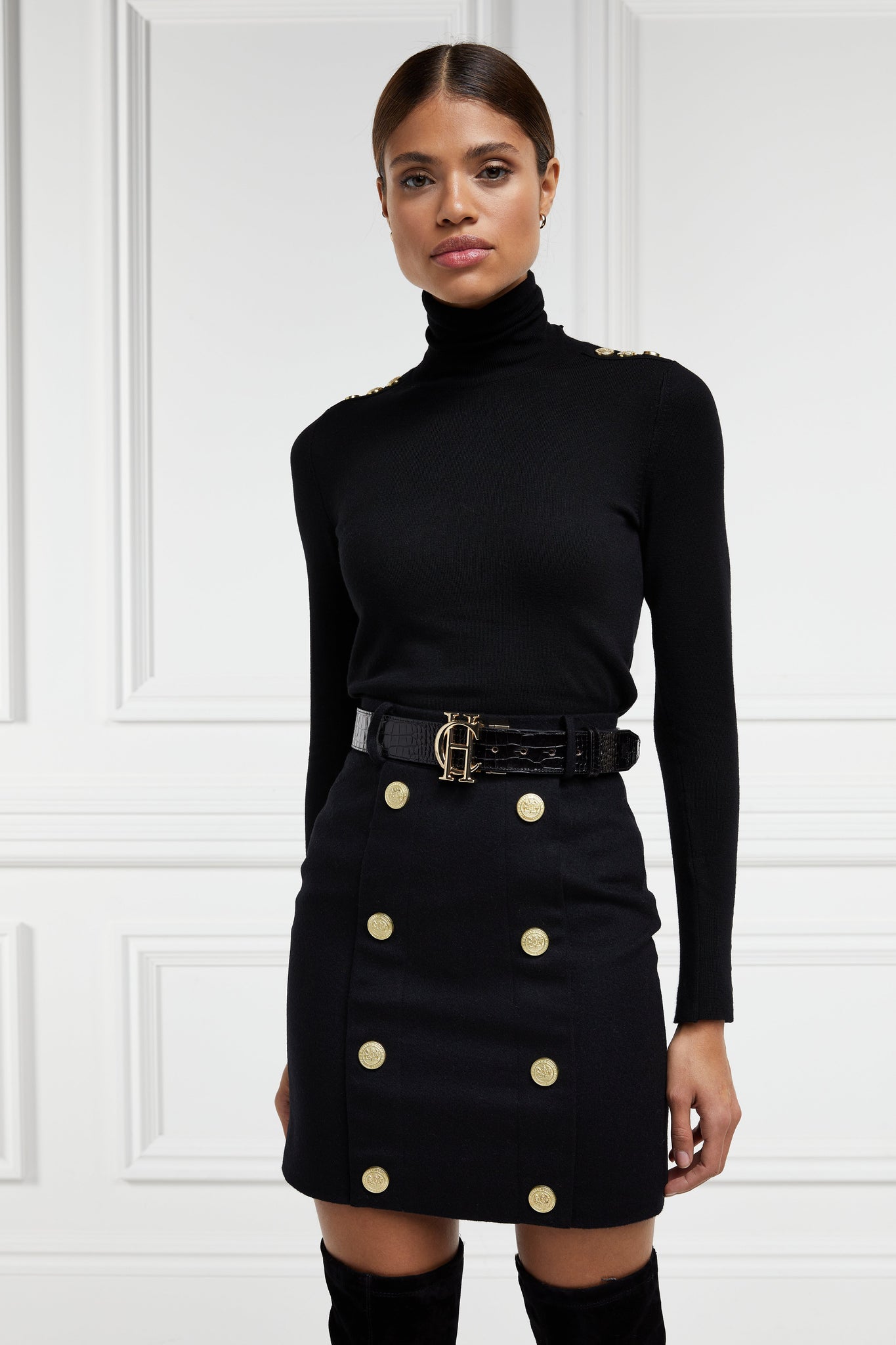 womens black wool pencil mini skirt with concealed zip fastening on centre back and gold rivets down front