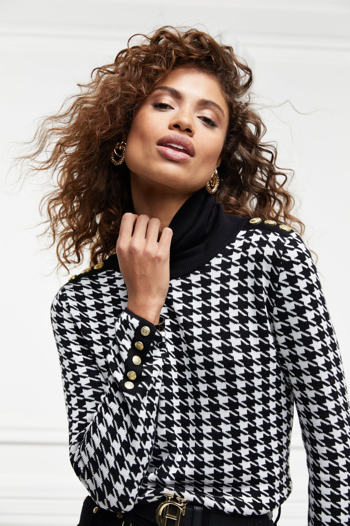 a classic black and white houndstooth jumper with contrast black roll neck collar