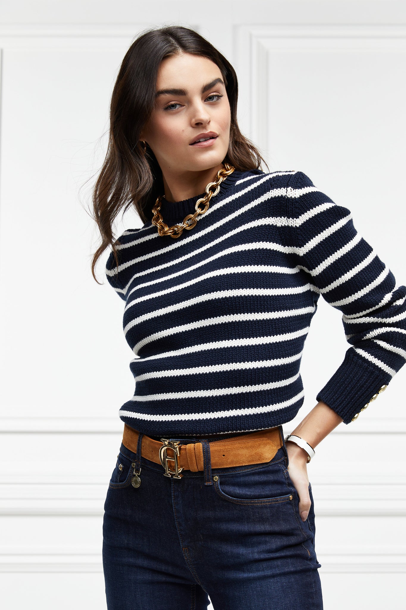 a classic navy and cream breton stripe crew neck jumper with a split ribbed hem and gold button detail on the cuffs and collar