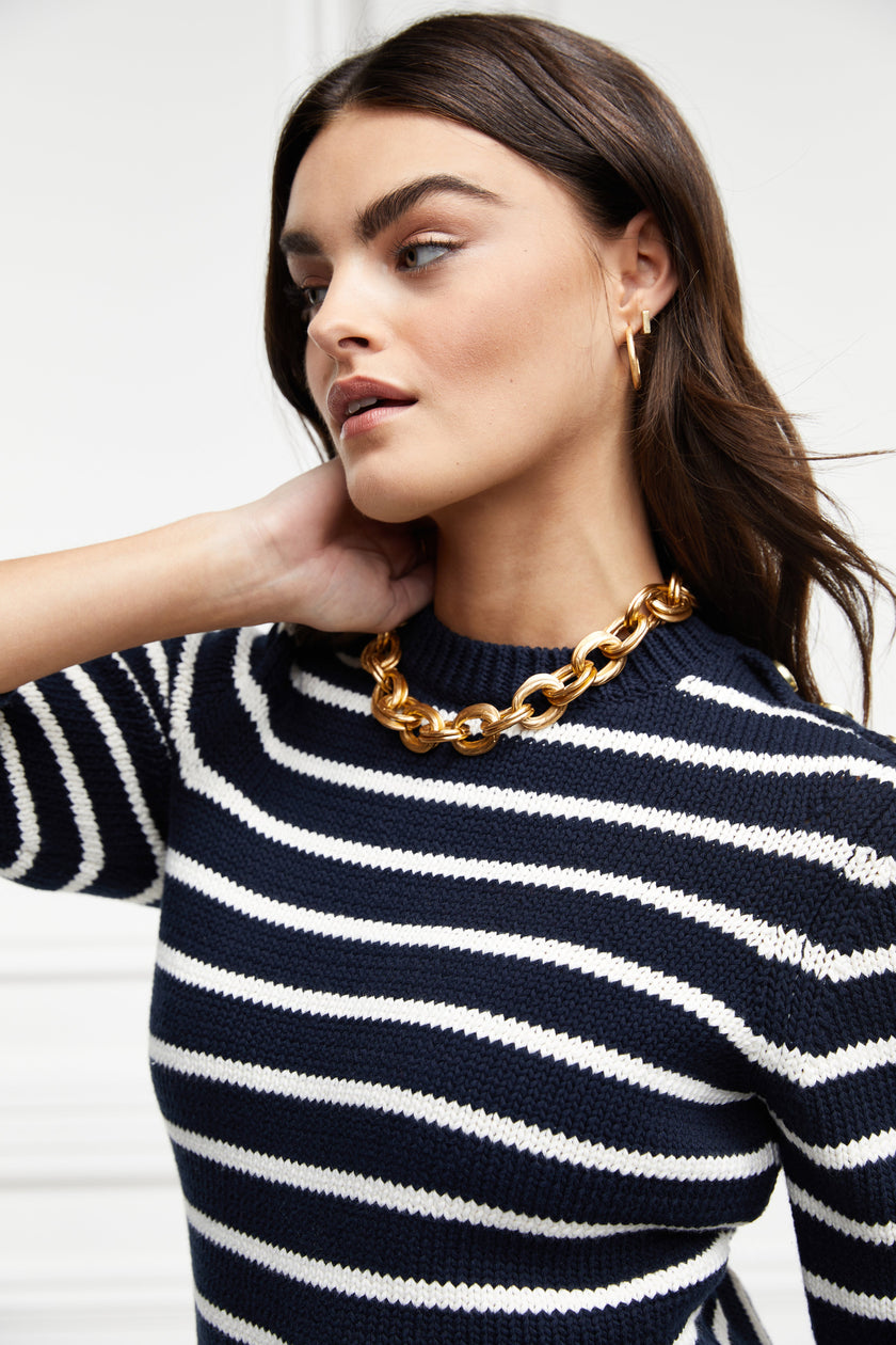 a classic navy and cream breton stripe crew neck jumper with a split ribbed hem and gold button detail on the cuffs and collar