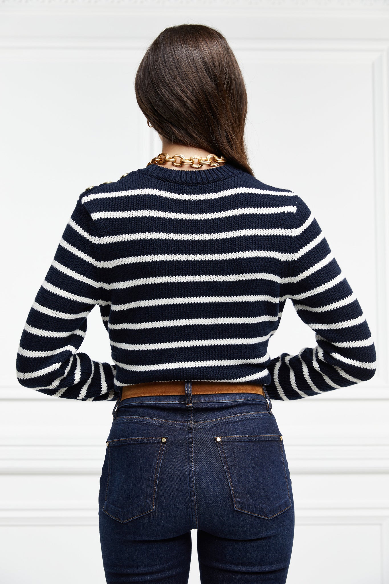 a classic navy and cream breton stripe crew neck jumper with a split ribbed hem and gold button detail on the cuffs and collar