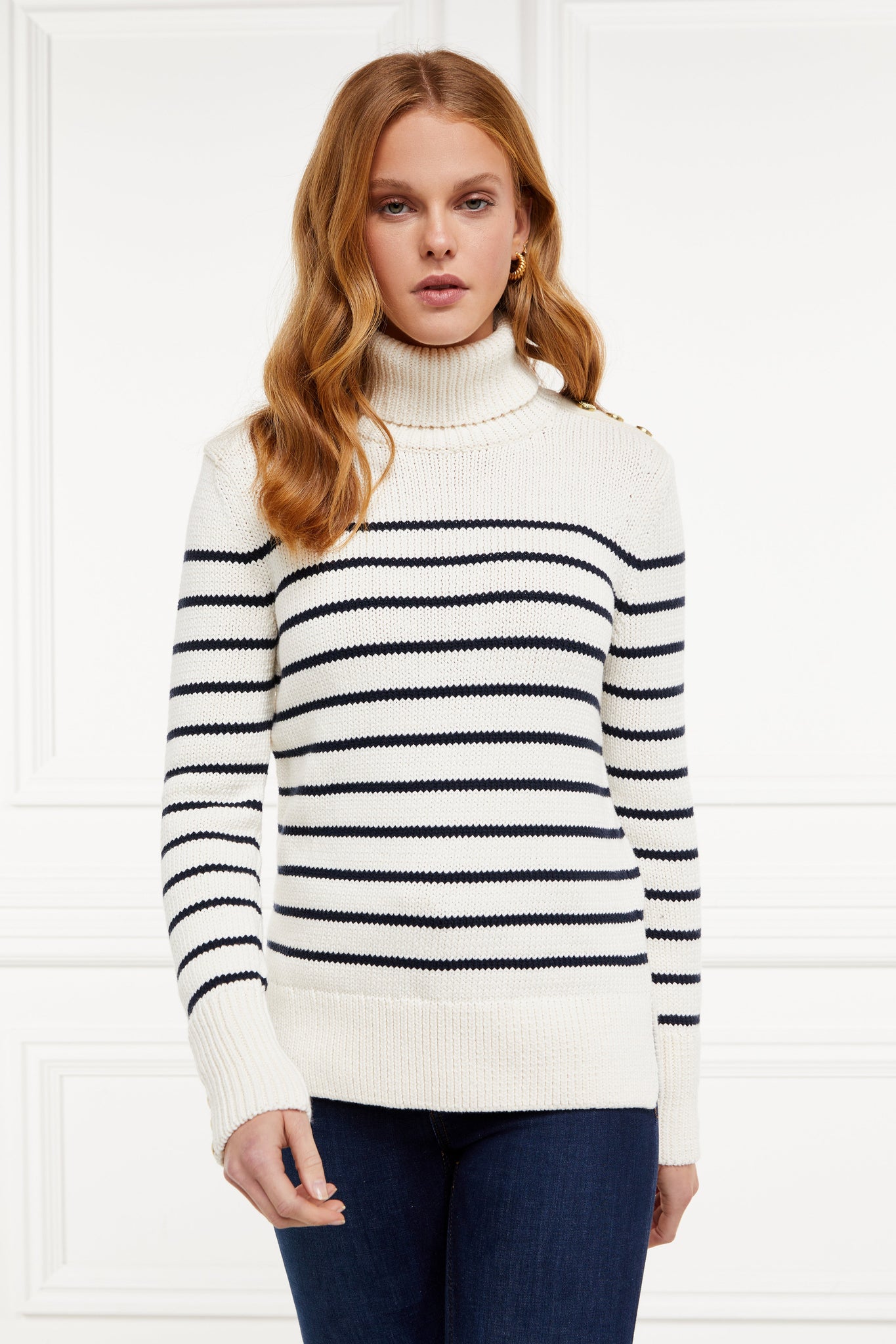 a classic cream and navy breton stripe roll neck jumper with a split ribbed hem and gold button detail on the cuffs and collar