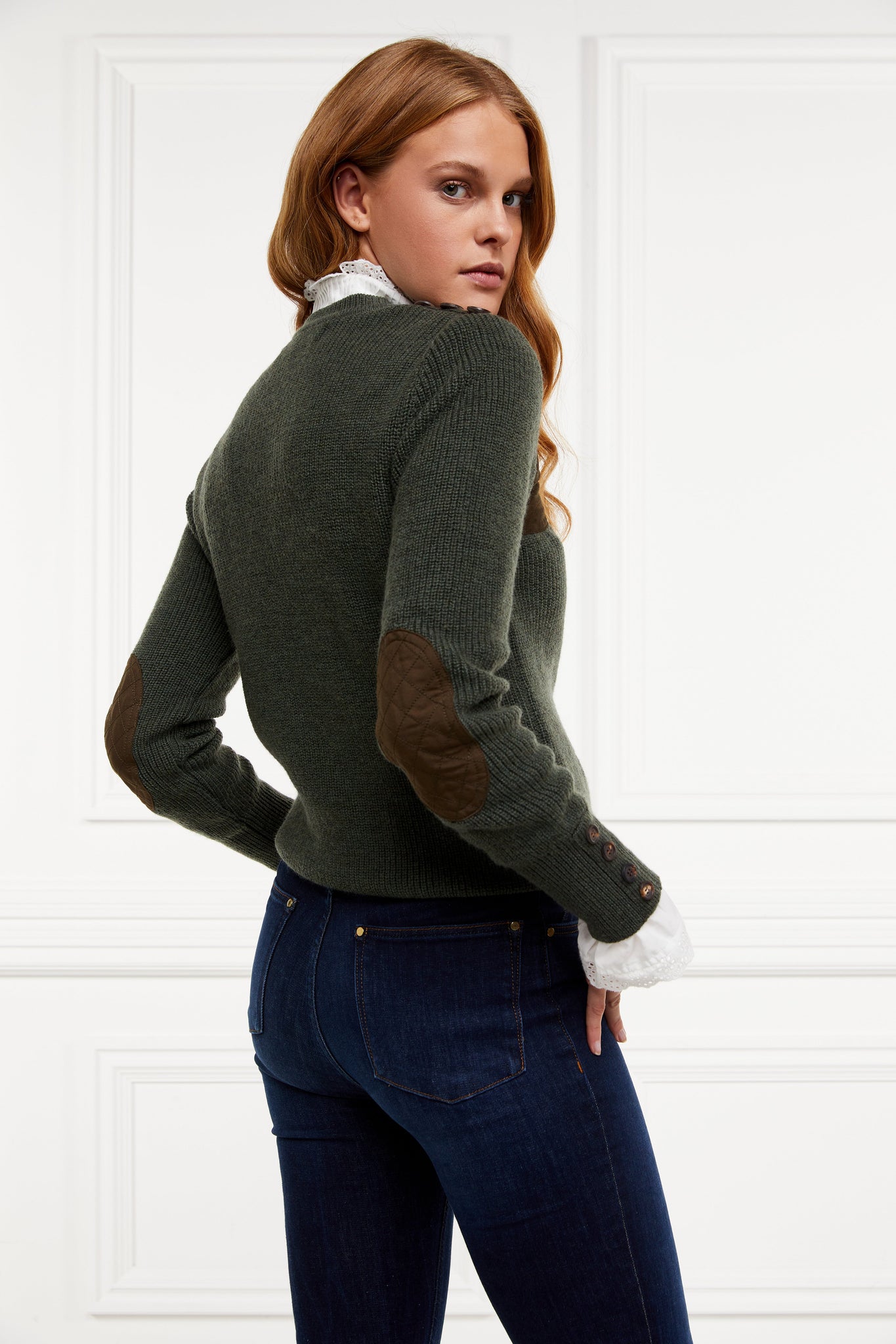 back of classic crew neck slim fit merino wool jumper in forest green with brown faux suede gunpatch on shoulder and quilted elbow patches in the same brown suede material