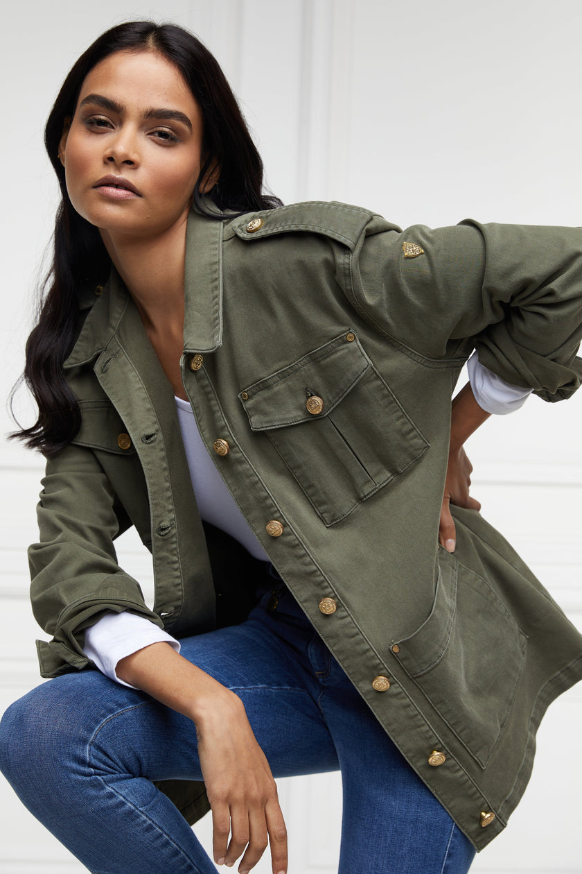 Relaxed fit collared artillery style jacket in khaki with four pockets two chest ones being box pleated  and two hip being patch pockets with gold jean button fastenings adjustable long sleeves and epaulette shoulder detail