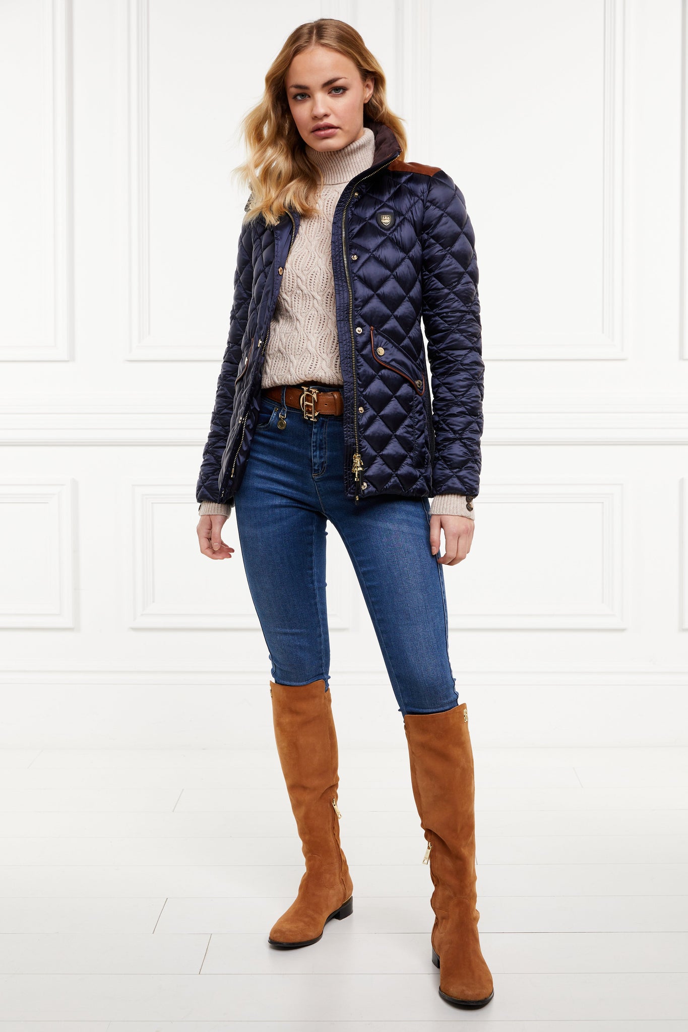 womens diamond quilted navy jacket with contrast tan leather elbow and shoulder pads large front pockets and shirred side panels