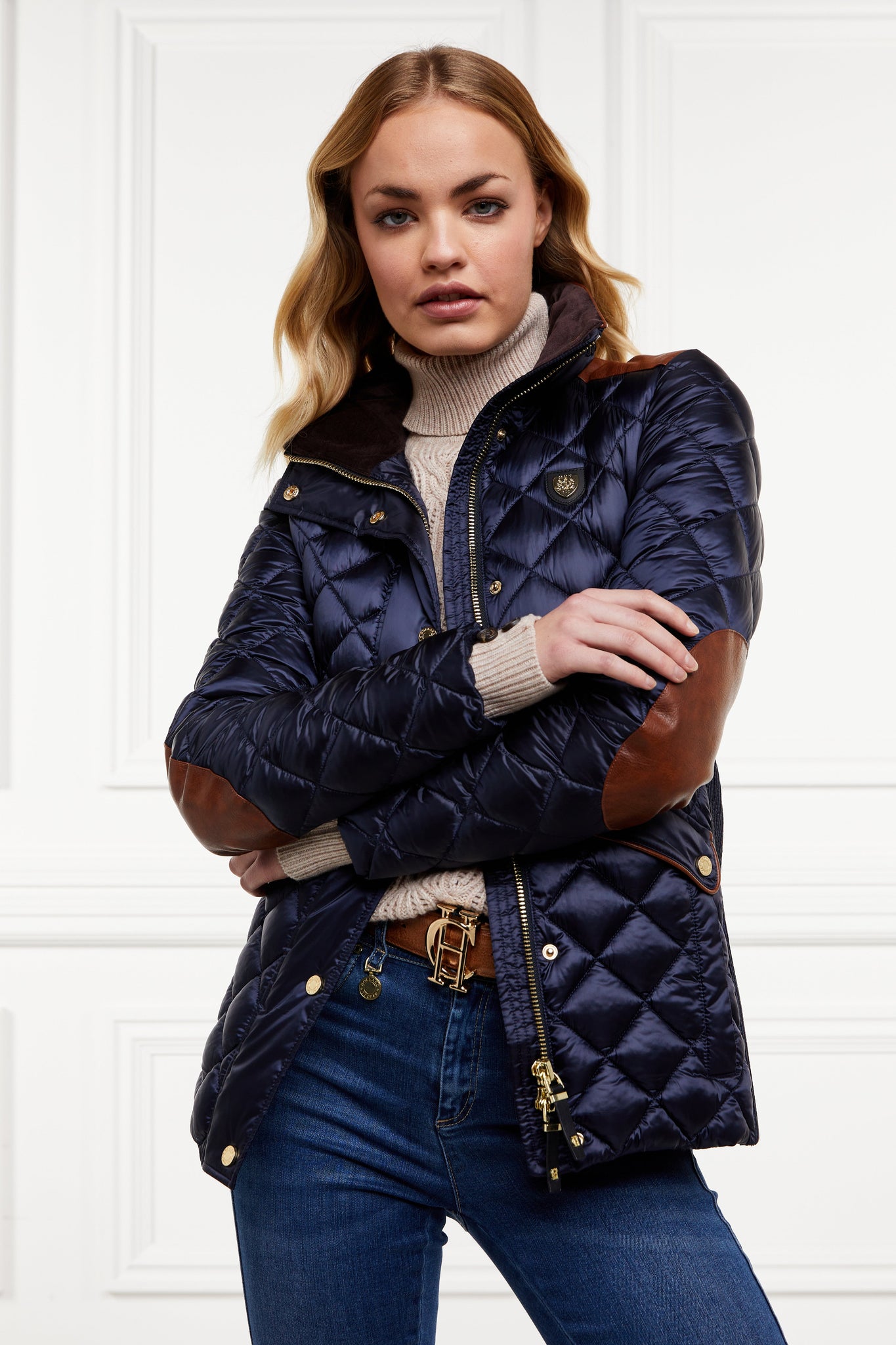 womens diamond quilted navy jacket with contrast tan leather elbow and shoulder pads large front pockets and shirred side panels