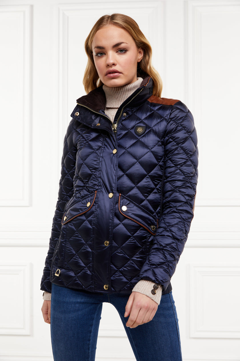 womens diamond quilted navy jacket with contrast tan leather elbow and shoulder pads large front pockets and shirred side panels