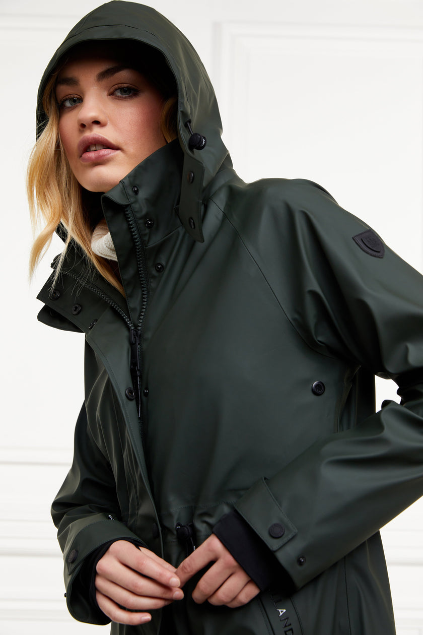 womens green hooded rain coat with black hardware 