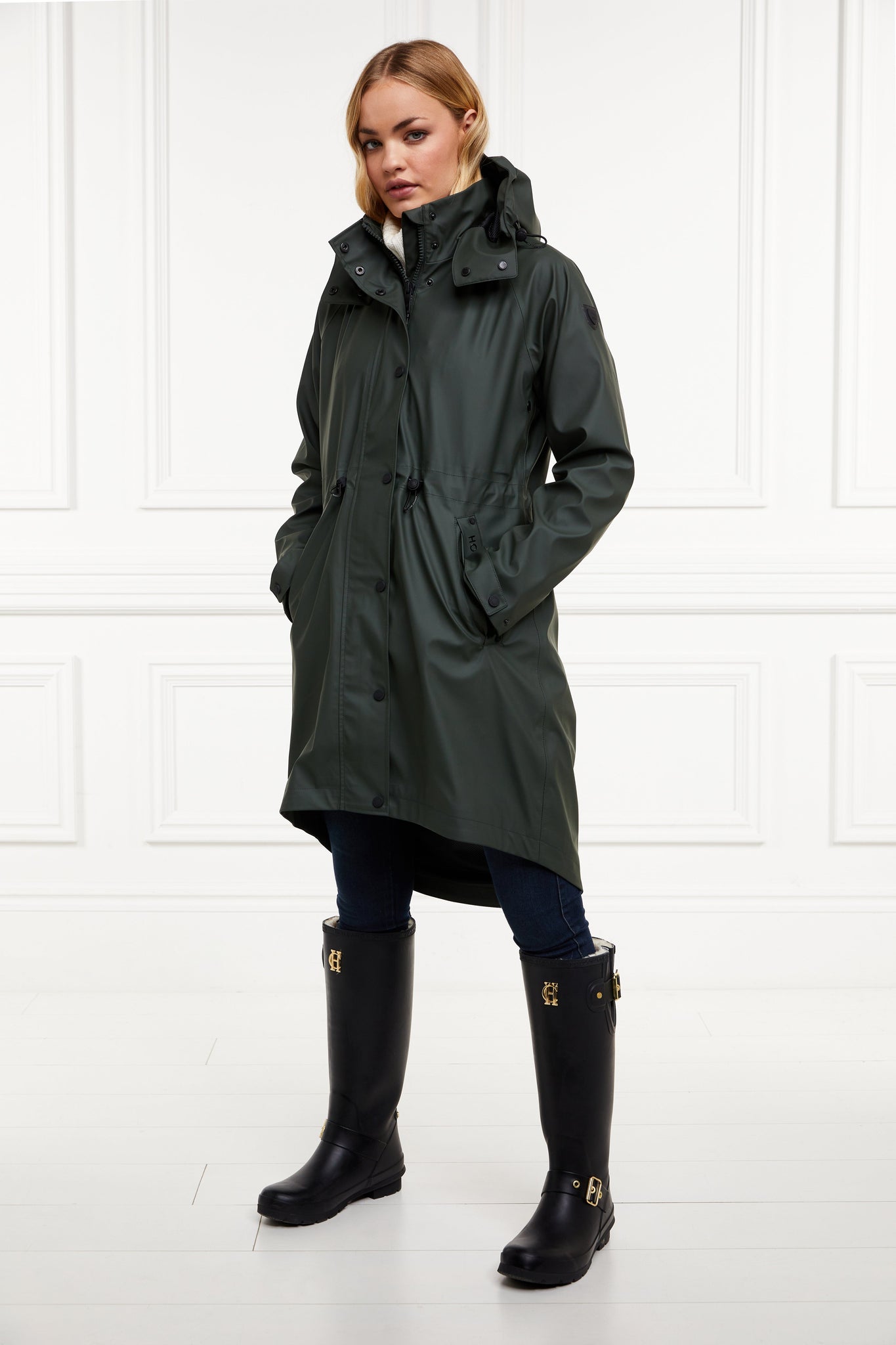 womens green hooded rain coat with black hardware 