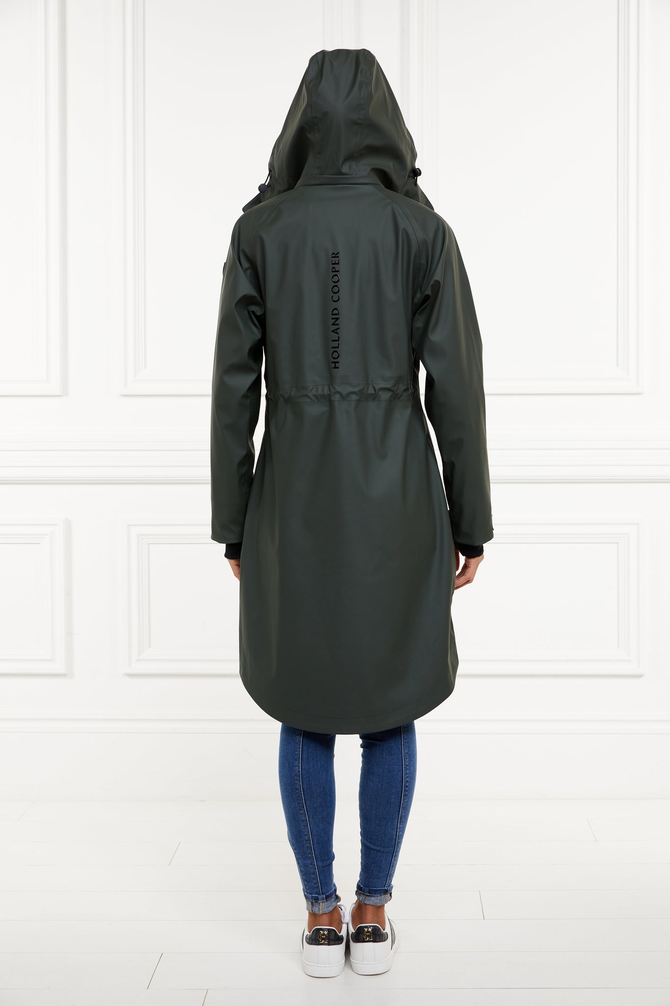 back of womens green hooded rain coat with black hardware 