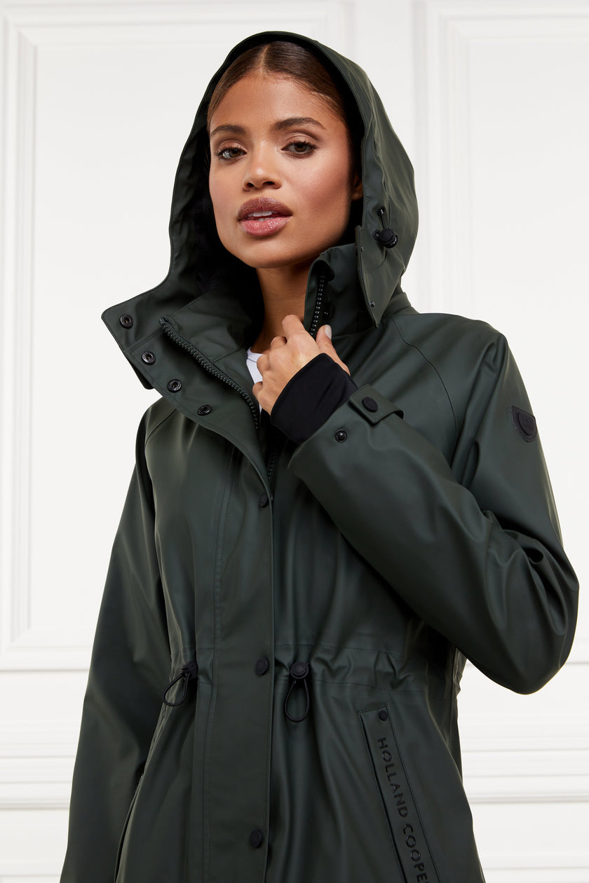 womens green hooded rain coat with black hardware 