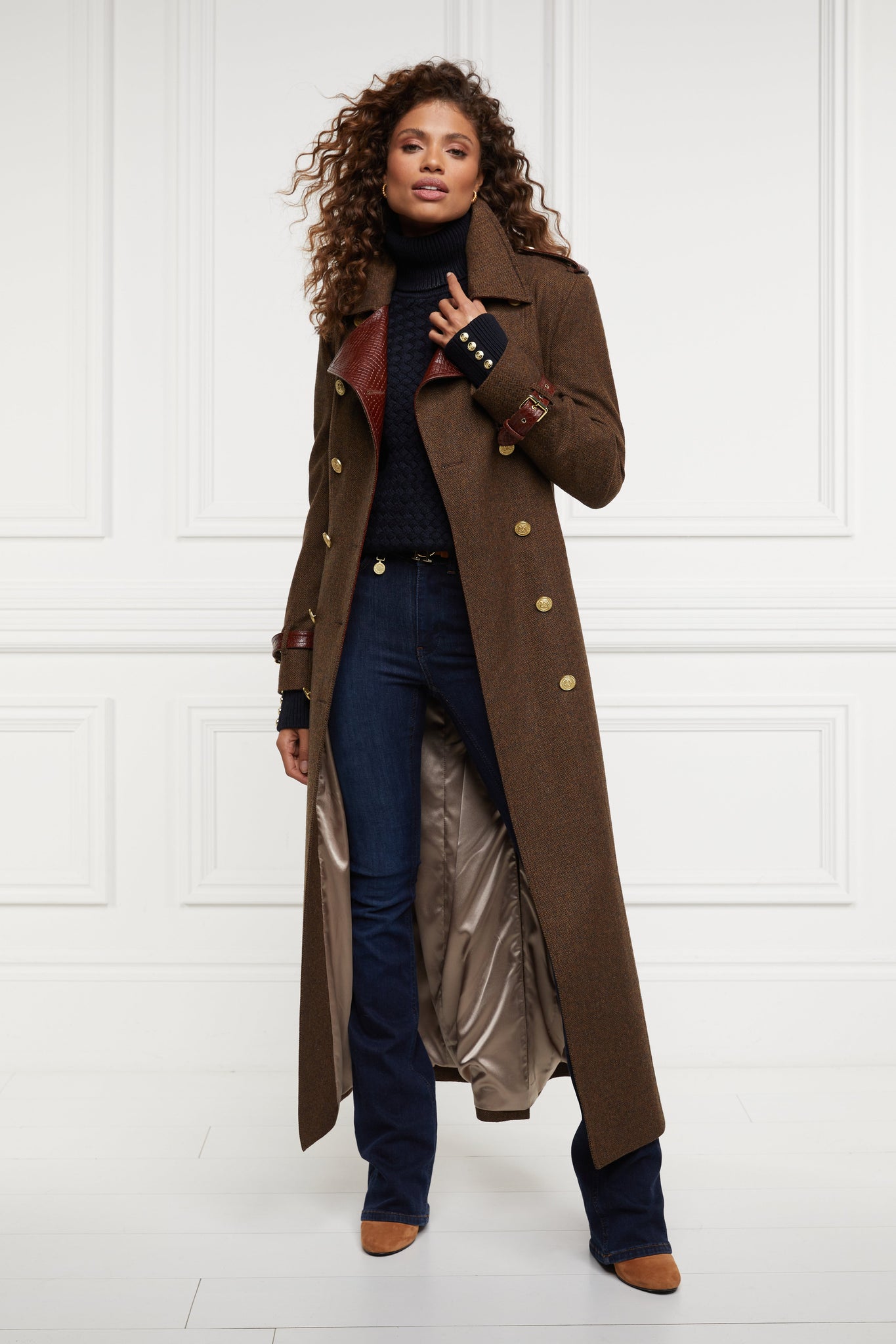 womens lightweight roll neck basket weave knit jumper in navy worn under a full length trench coat in brown herringbone