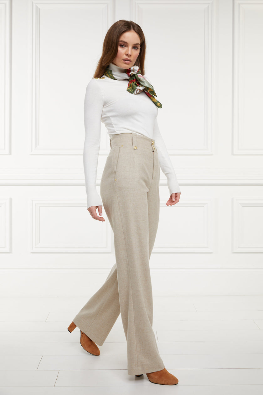 Women's oatmeal wool high waisted straight trouser with white roll neck top and silk scarf around the neck 