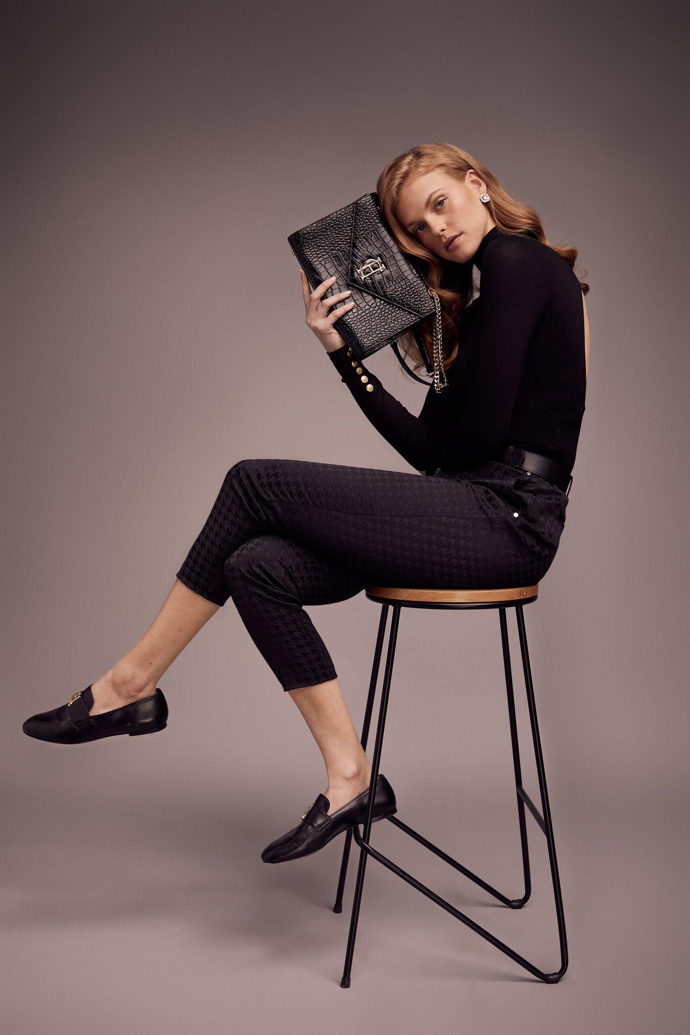 womens black open back bodysuit with grey houndstooth jacquard chinos and black croc embossed leather shoulder bag with gold hardware and chain