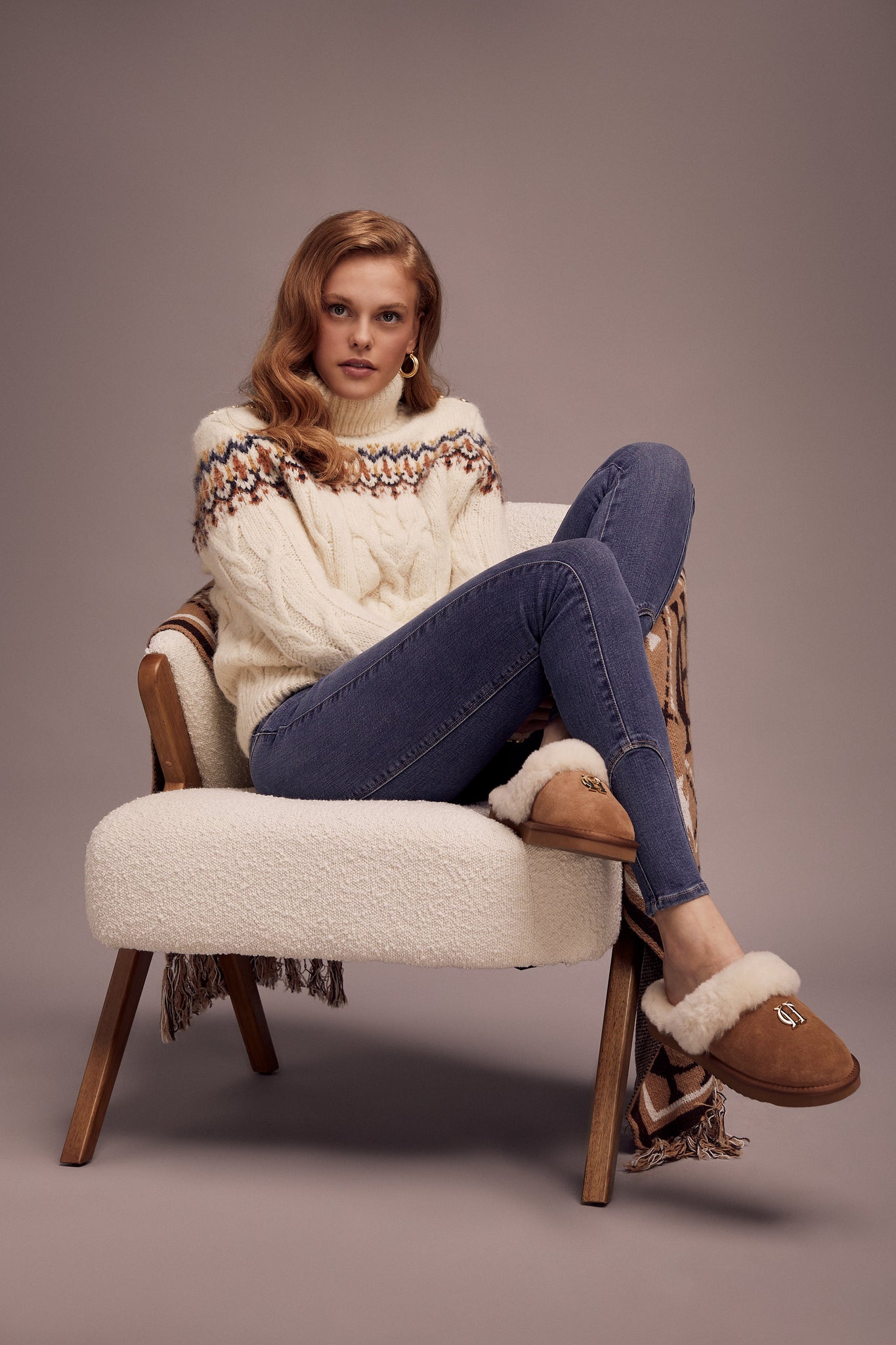 high roll neck cable knit jumper in cream with a blue orange and yellow fairisle knit detail across the chest around the upper arm and back