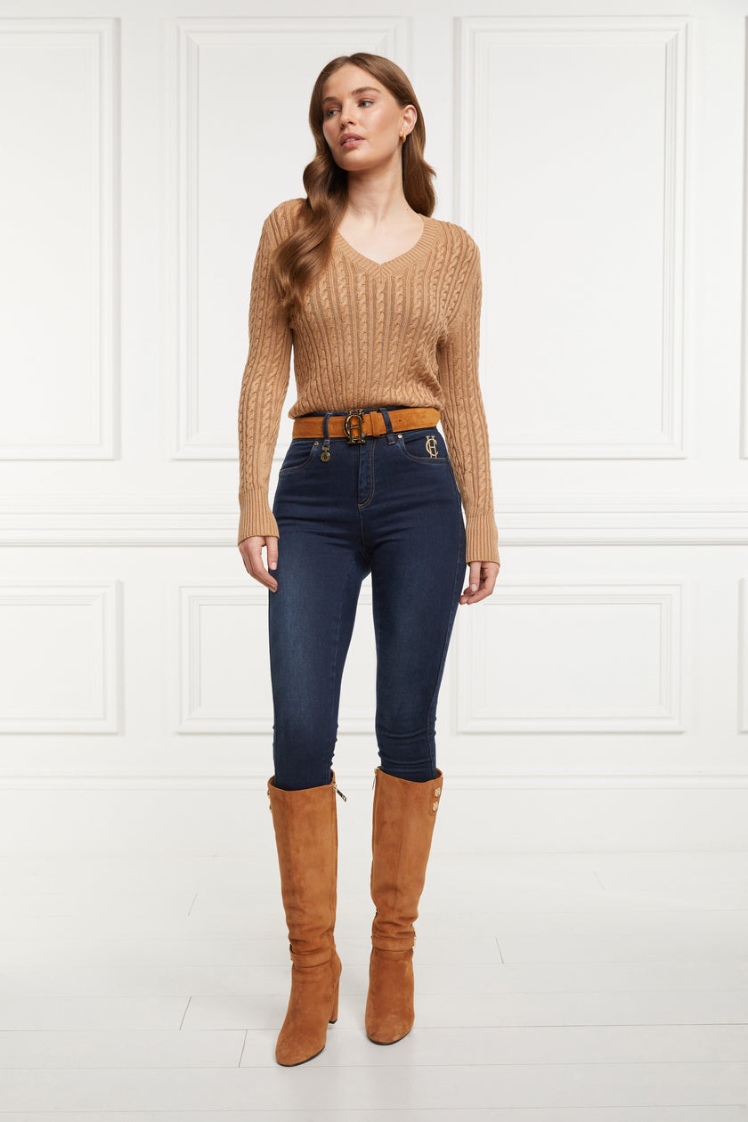 womens lightweight v neck cable knit jumper in dark caramel detailed with gold buttons at the cuffs paired with dark denim jeans and tan knee high boots