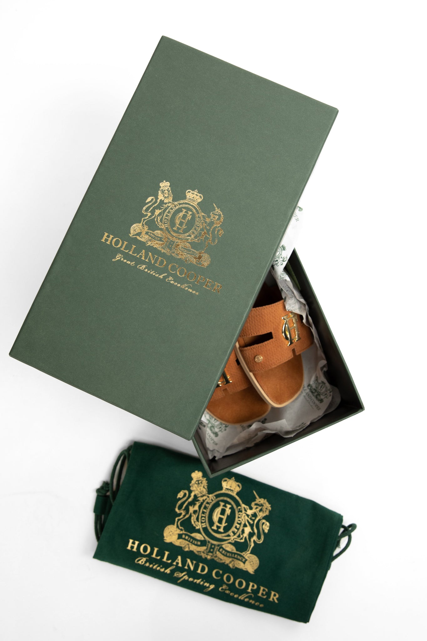 tan suede sliders with a tan leather sole and gold hardware in box packaging with dust bag