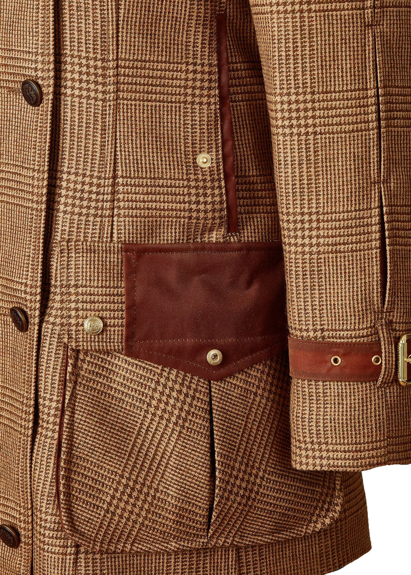 Closed pocket detail of tan brown tartan tweed field coat