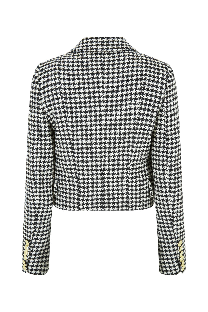 back of British made tailored cropped jacket in black and white houndstooth with welt pockets and gold button detail down the front and on sleeves