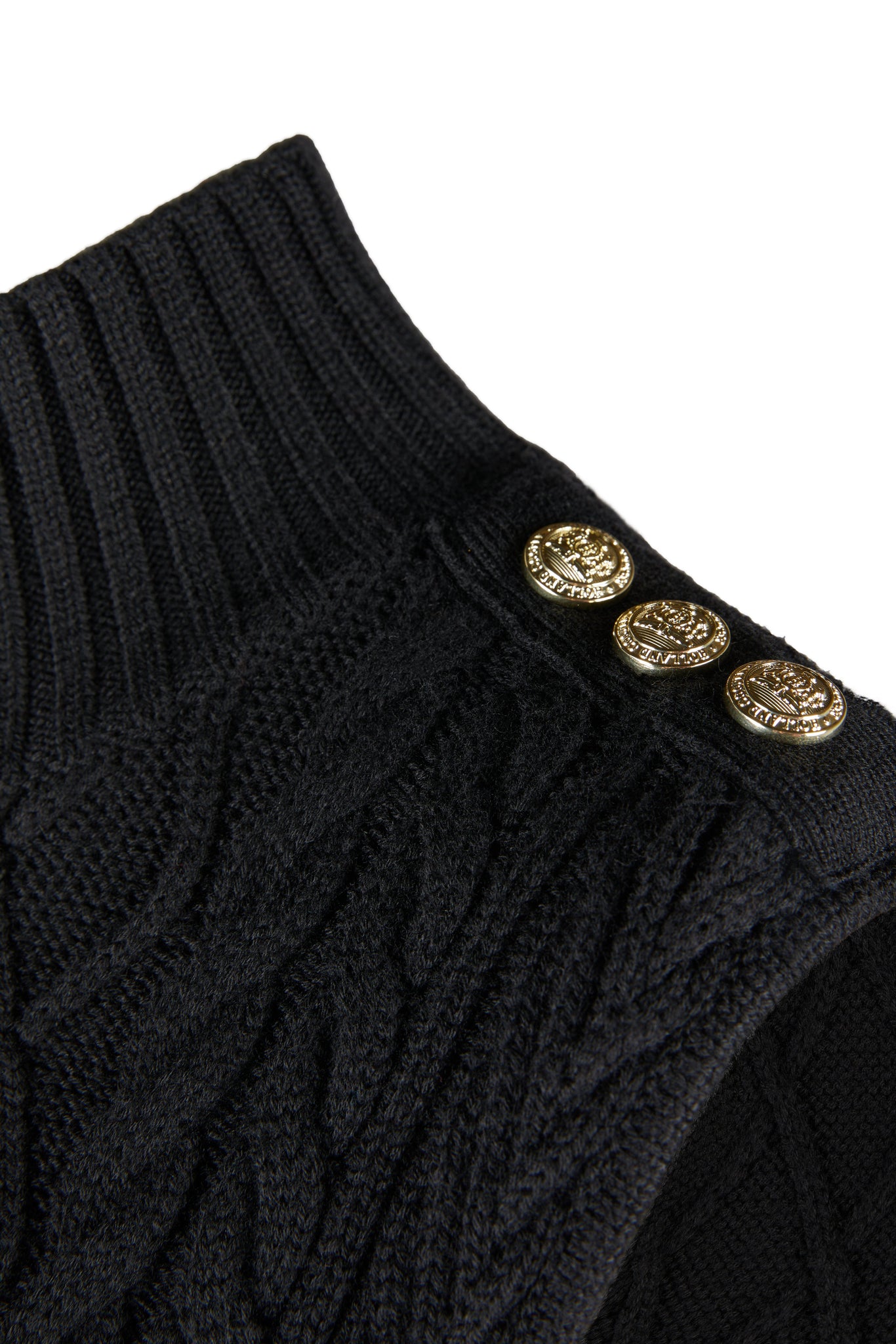 gold button detail across shoulders of womens black sleeveless cable knit mini dress with ribbed hem and turtle neck