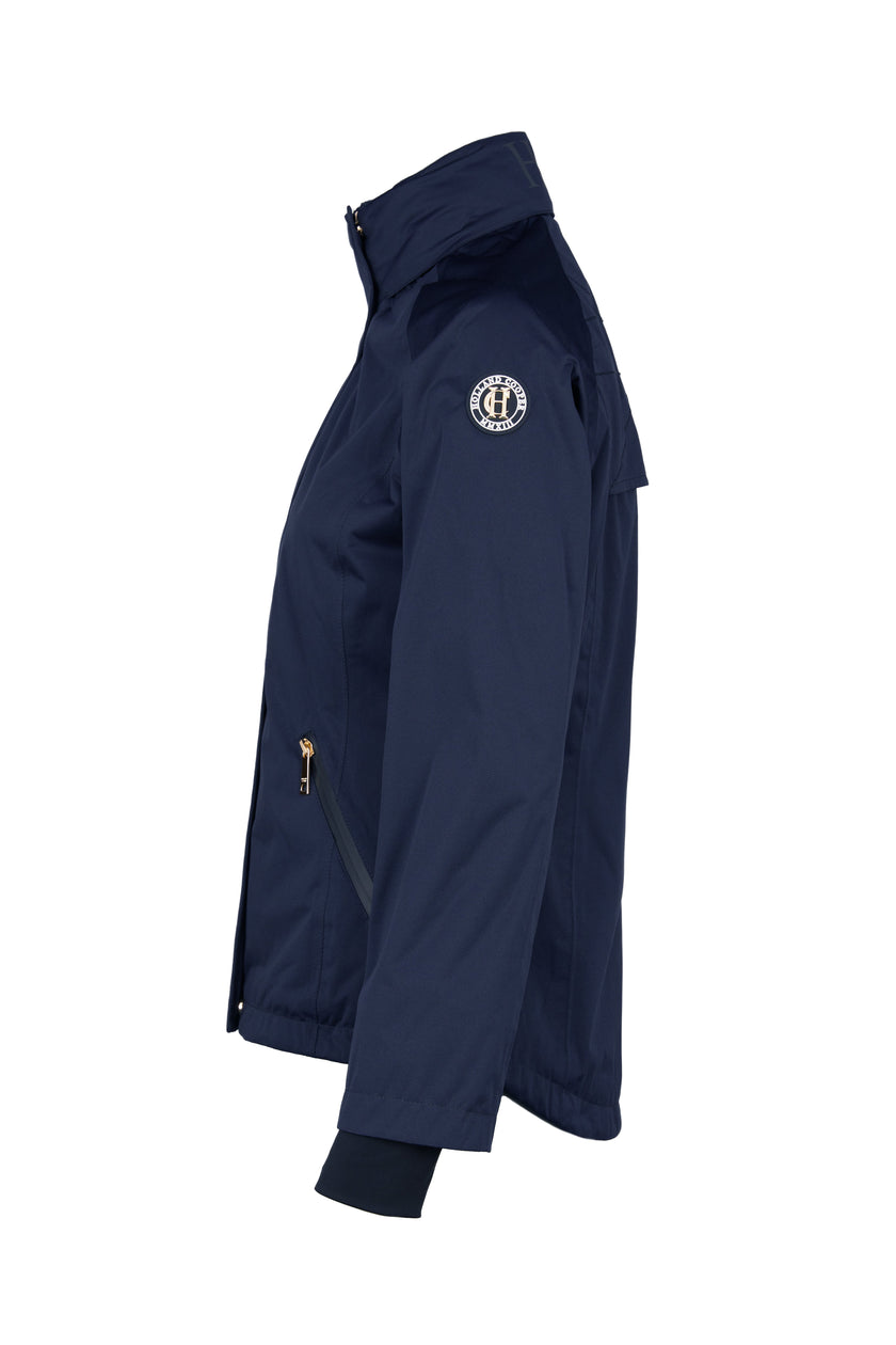 side of Womens waterproof navy jacket with stowaway hood storm cuffs and two pockets at hip with waterproof zip fastening