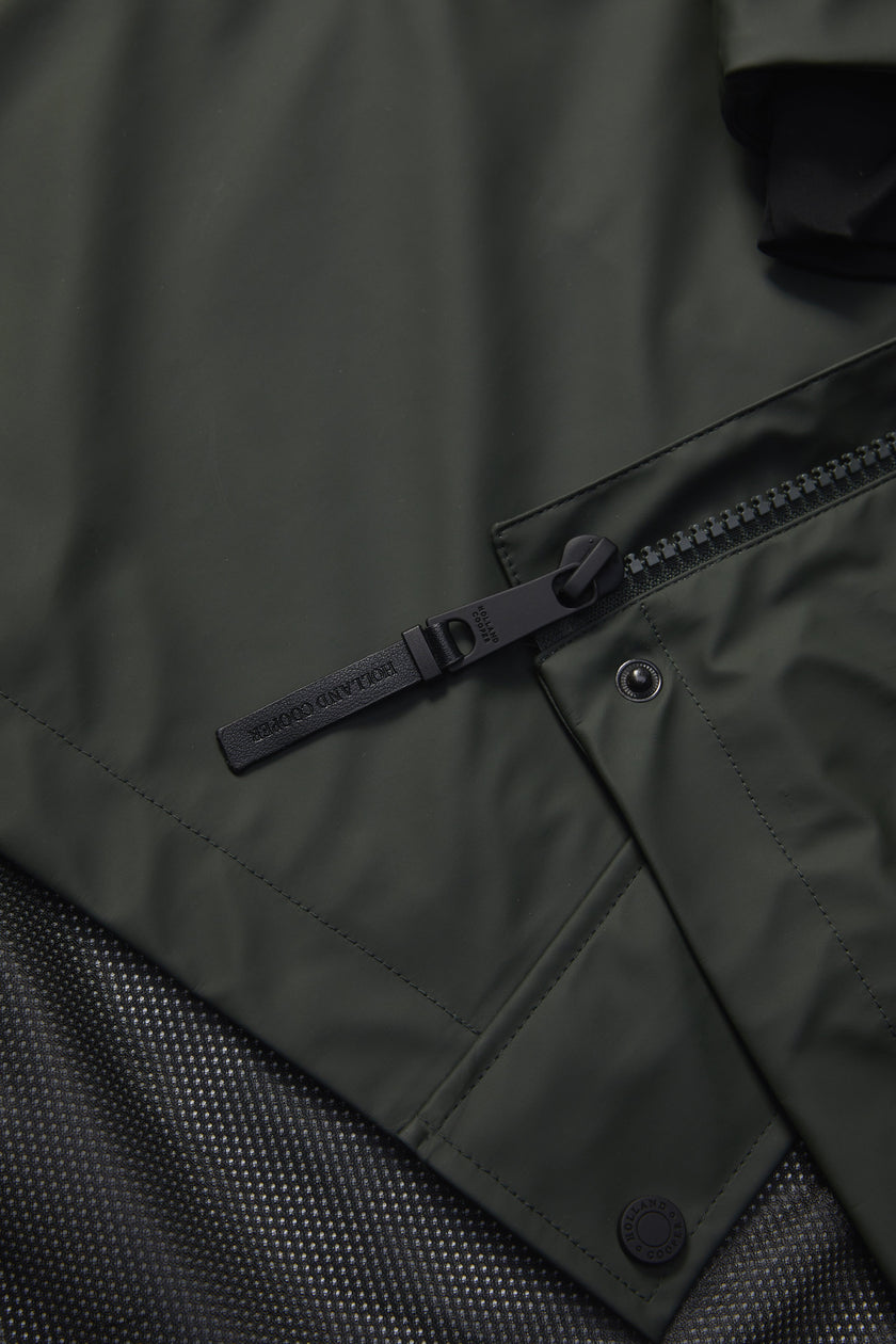 detail of womens green hooded rain coat with black hardware 