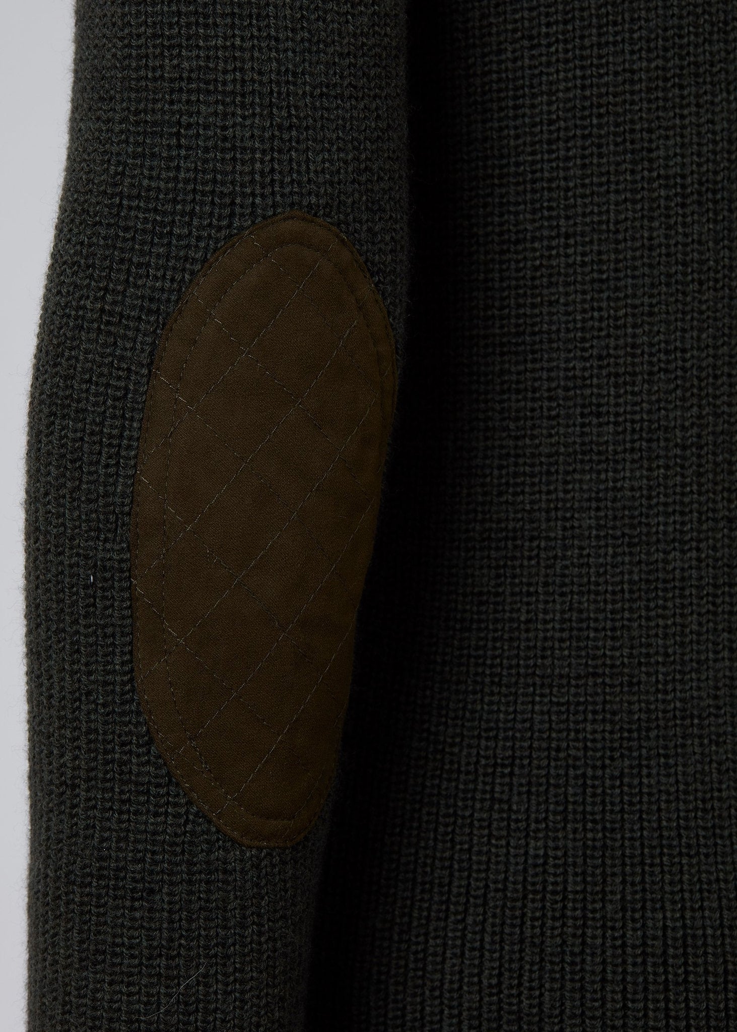 brown faux suede quilted elbow patch detail on classic crew neck slim fit merino wool jumper in forest green with gunpatch on shoulder  in the same brown suede material