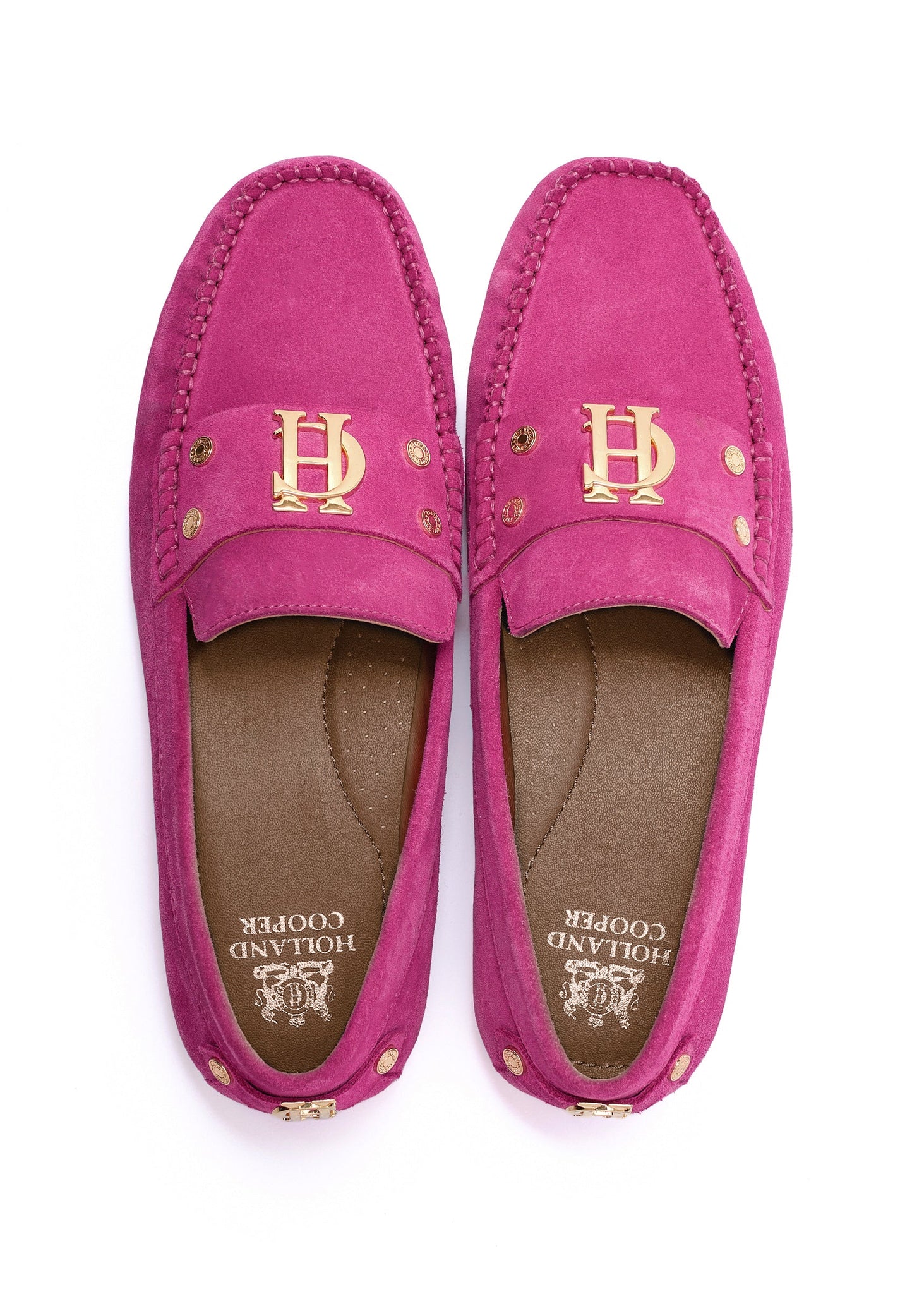 bright pink suede loafers with a leather sole and top stitching details and gold hardware with gold foil branding on the inner sole