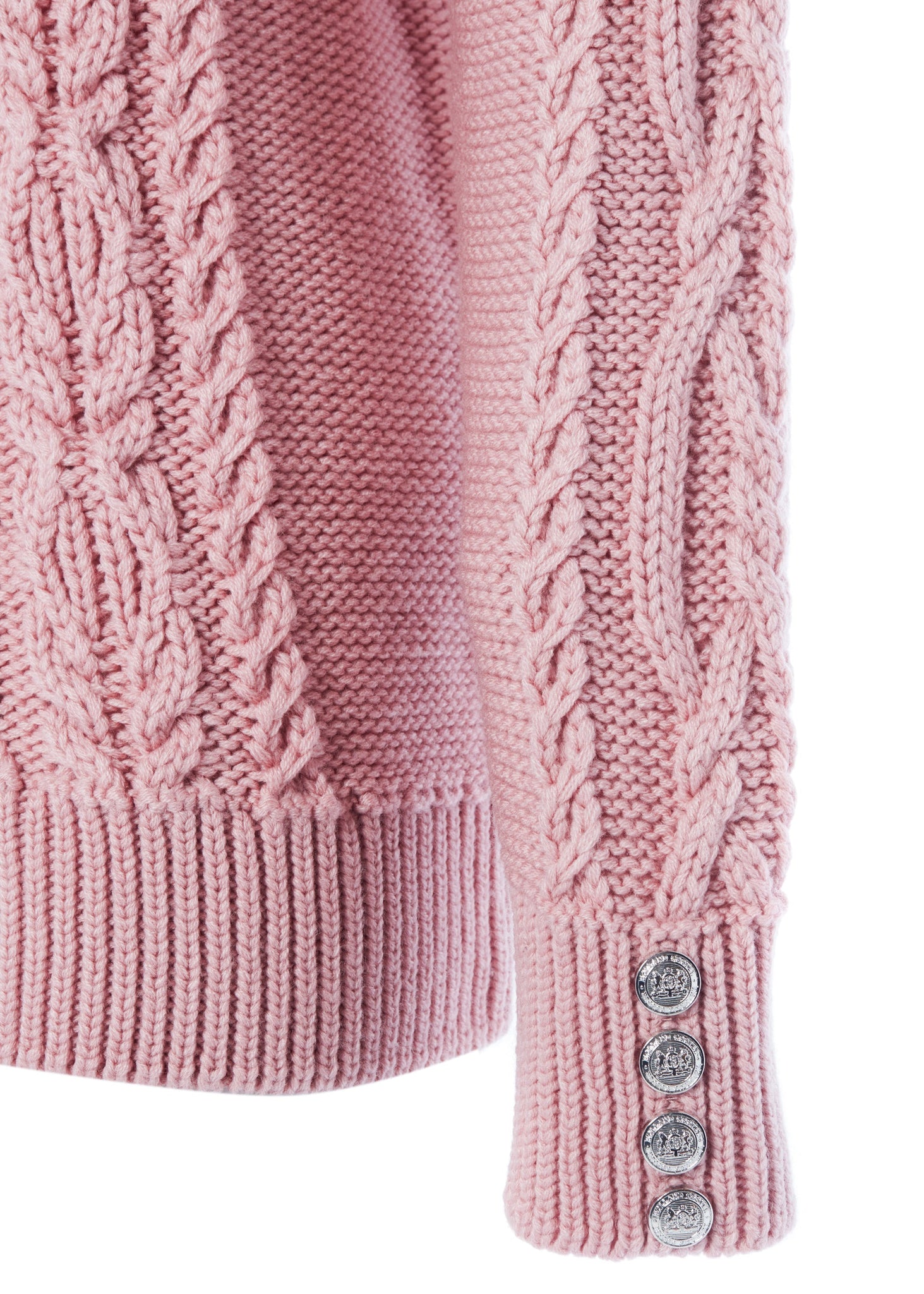 silver button detail on cuffs of chunky cable knit jumper in blush pink with ribbed roll neck hem and cuffs