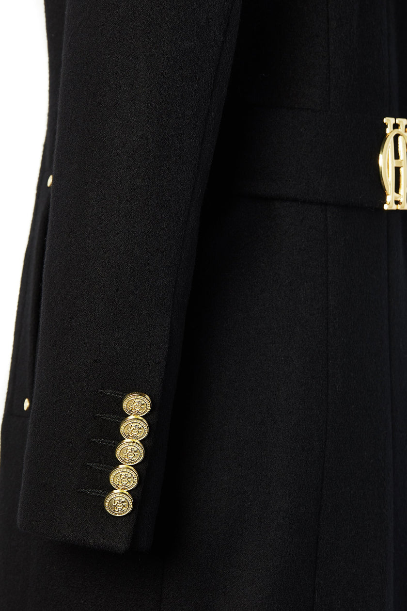 gold button sleeve detail on black single breasted full length wool coat