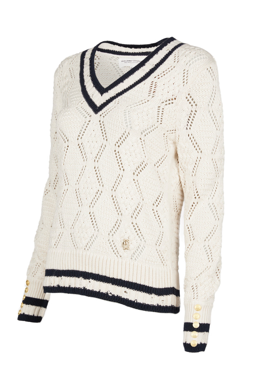 A cricket style v neck lightweight knit in cream with thick ribbed navy double stripe trims on cuffs and neckline 