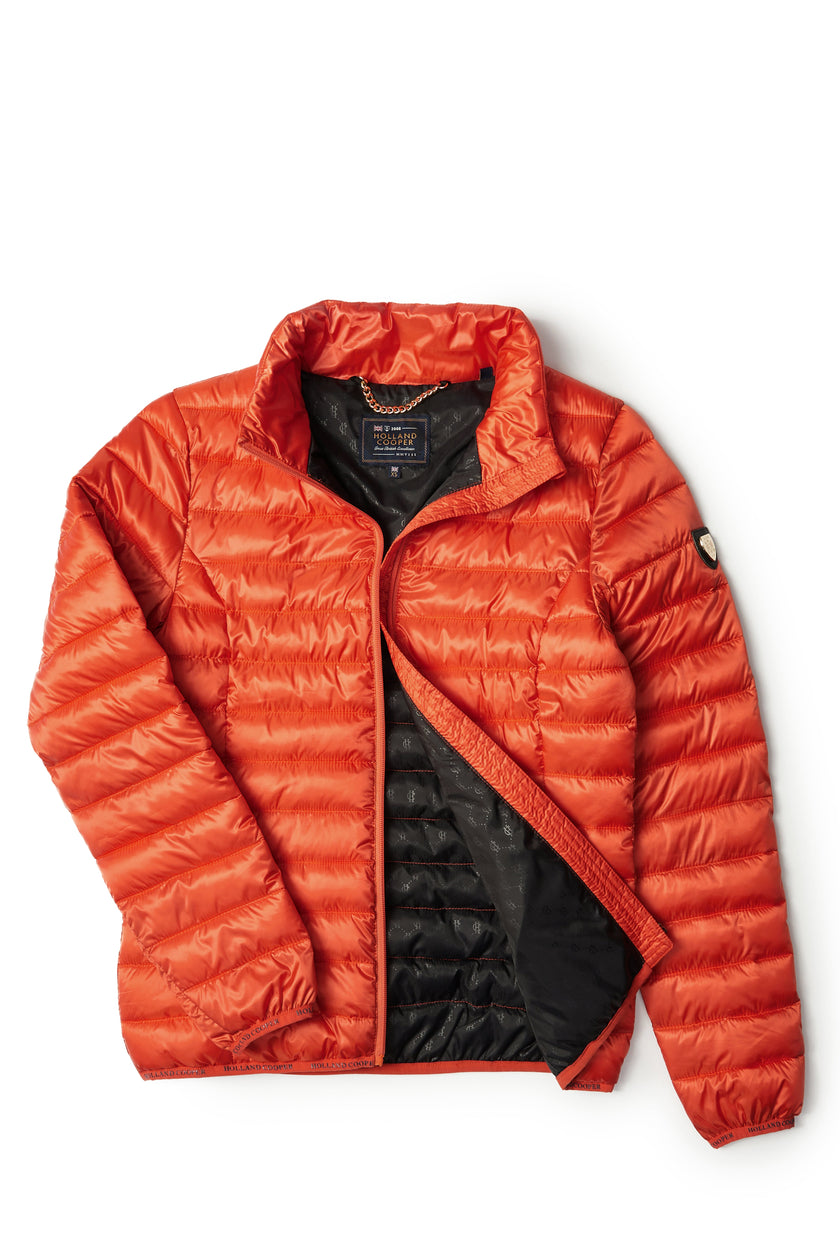 womens lightweight hoodless padded orange jacket with embroidery detail on back high neck and elasticated cuffs and hem. easily packs away into separate small bag of the same colour with handle 