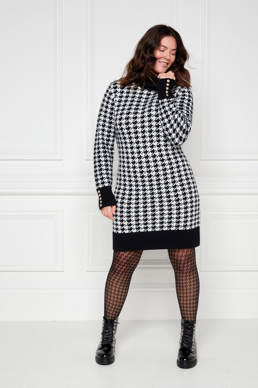 womens black and white houndstooth roll neck jumper dress with contrast black cuffs and ribbed hem with gold button detail on the cuffs and shoulders