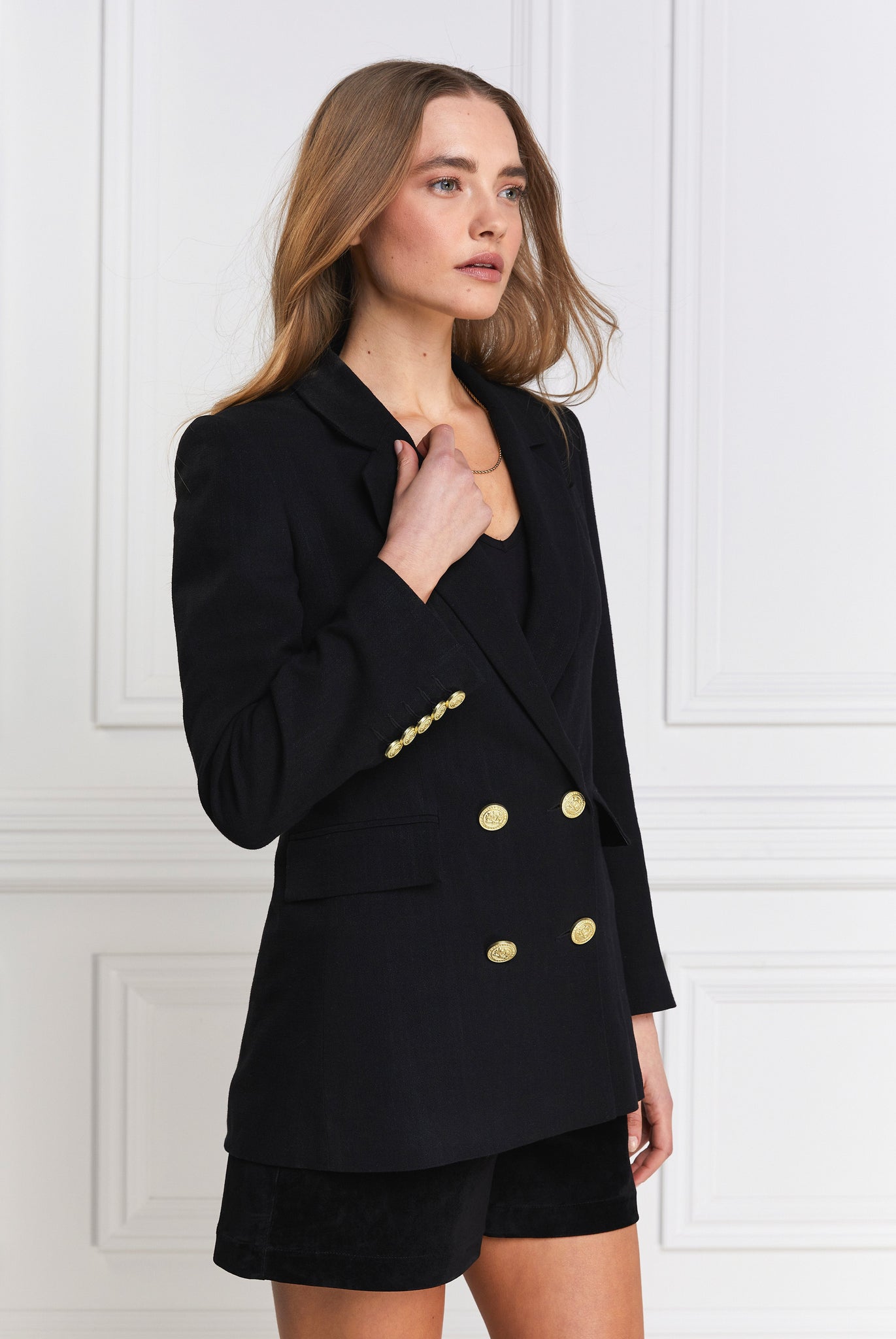 double breasted linen blazer in black with two hip pockets and gold button details down front and on cuffs and handmade in the uk