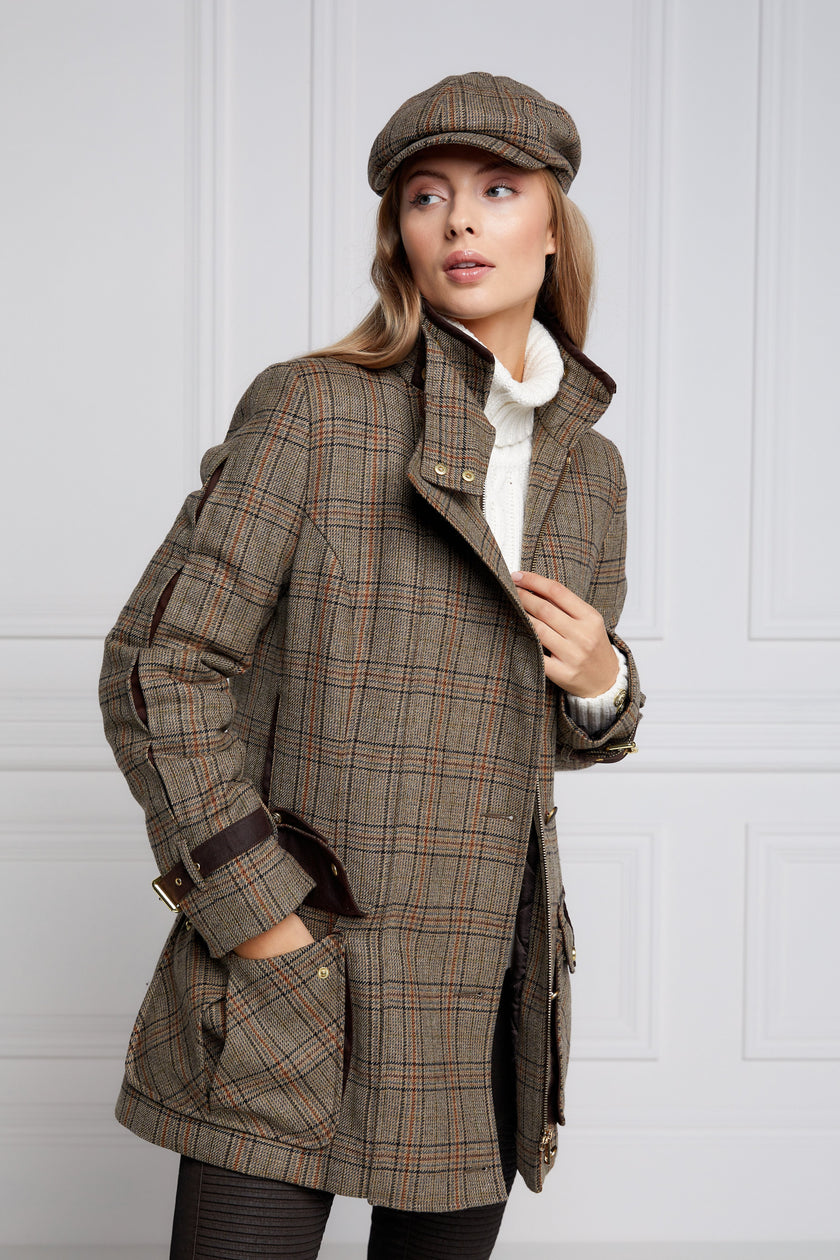 Woman in brown tartan tweed field coat and baker boy cap