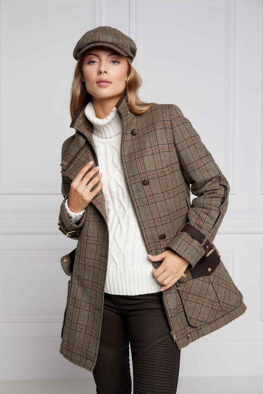 Woman in brown tartan tweed field coat and baker boy cap