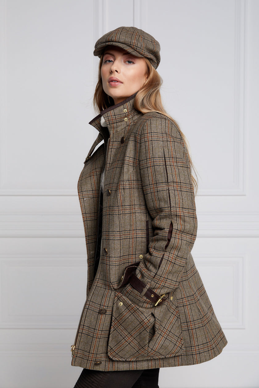 Woman in brown tartan tweed field coat and baker boy cap