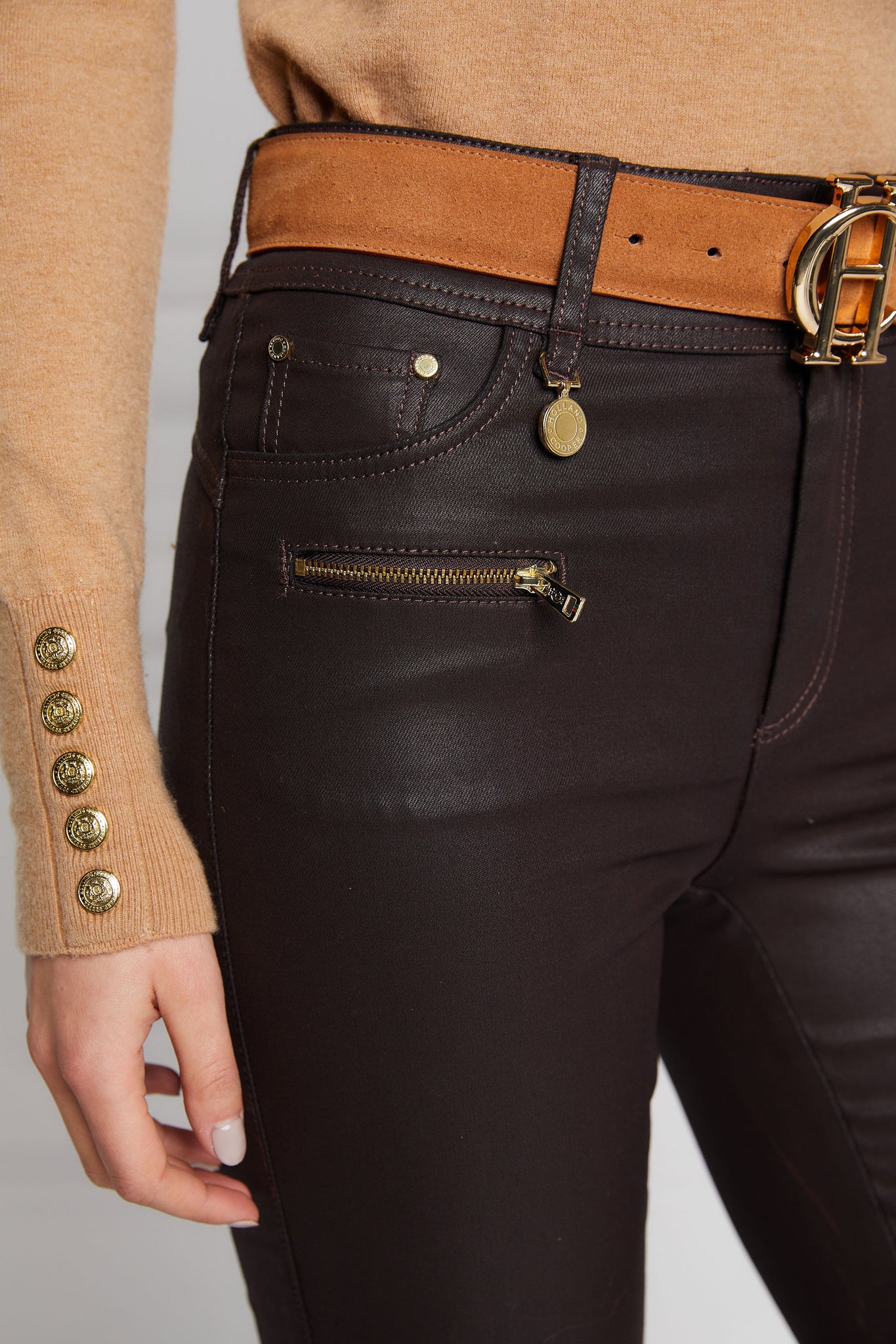 front pocket detail on womens high rise brown coated skinny jean for a waxed look with jodhpur style seams and two open zip pockets to the front with HC branded pulls