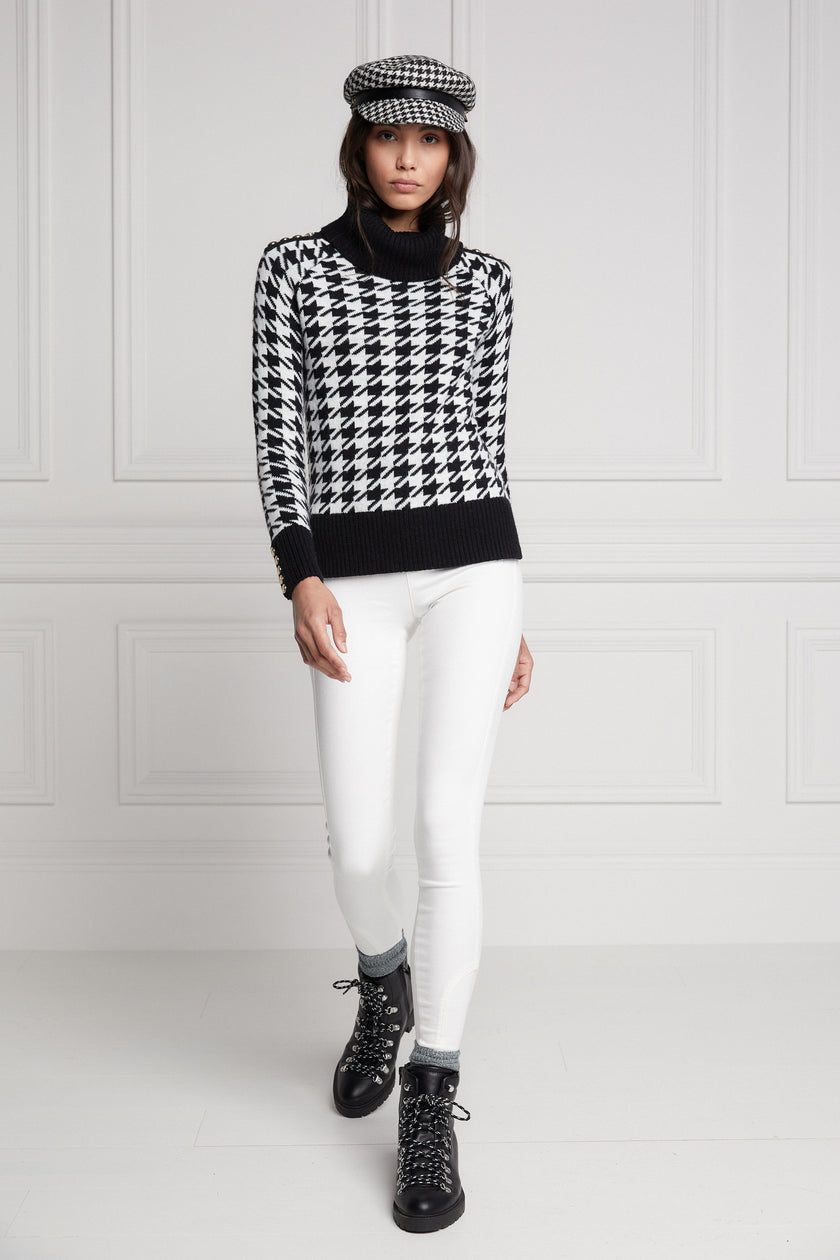 a classic black and white houndstooth jumper with contrast black cuffs, roll neck and split ribbed hem with gold button detail on the cuffs and collar