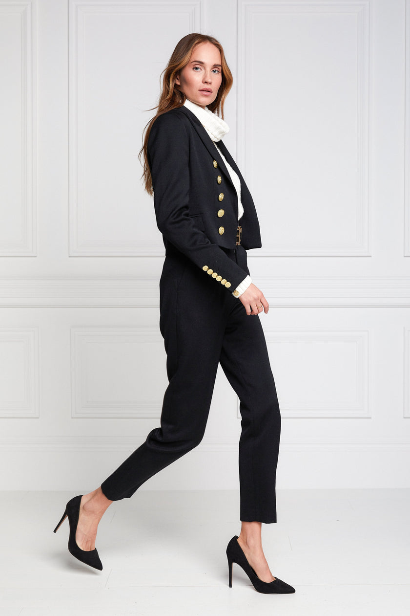 British made tailored cropped jacket in black with welt pockets and gold button detail down the front and on sleeves