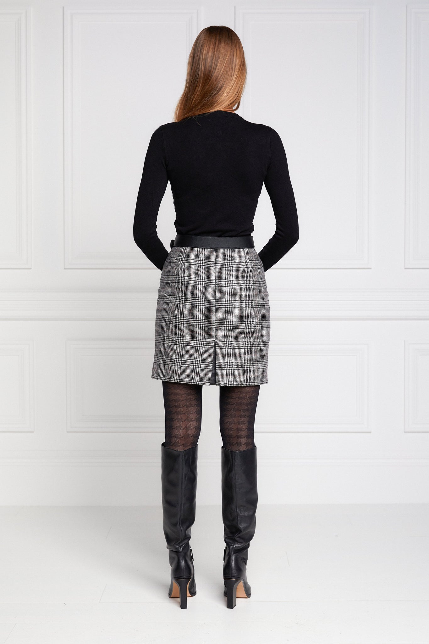 back of womens wool tweed pencil mini skirt in black and white check with slit on back and zip fastening on centre back