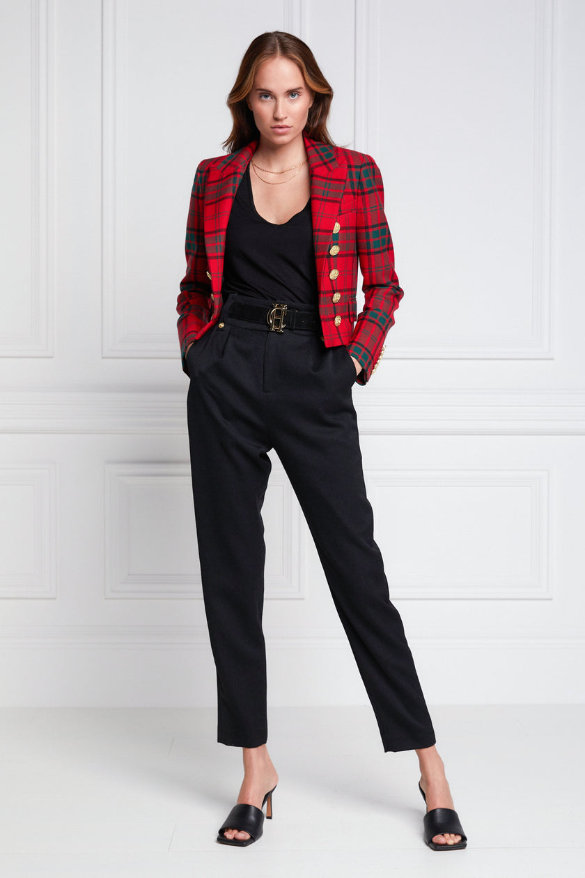 British made tailored cropped jacket in red and green tarten with welt pockets and gold button detail down the front and on sleeves worn with black crew neck top and black tailored trousers