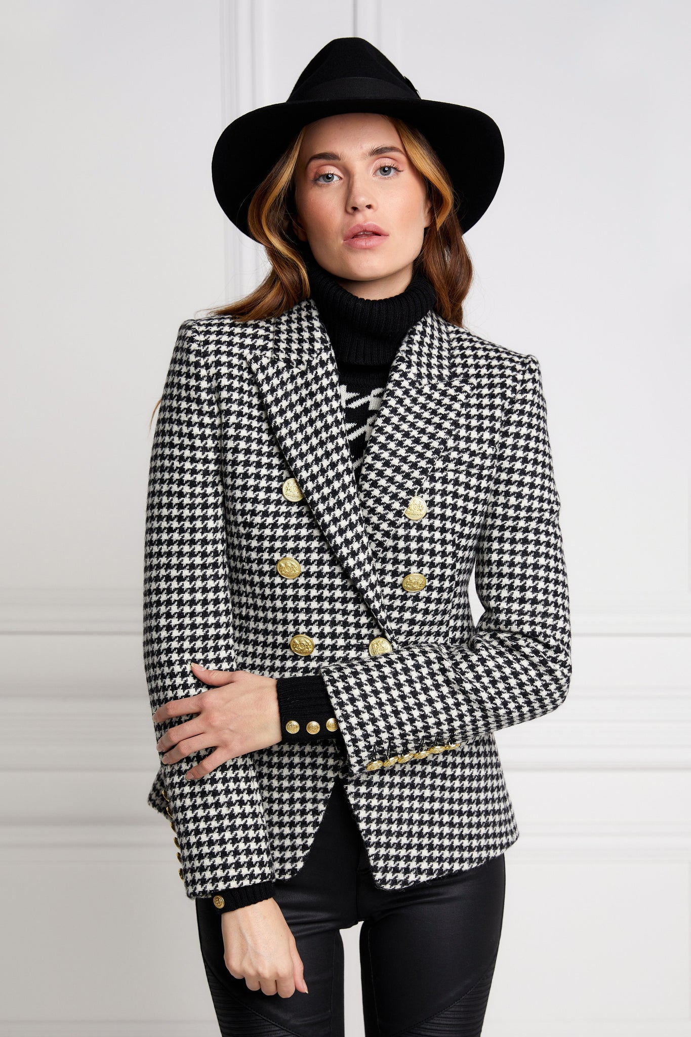 British made double breasted blazer that fastens with a single button hole to create a more form fitting silhouette with two pockets and gold button detailing this blazer in black and white houndstooth