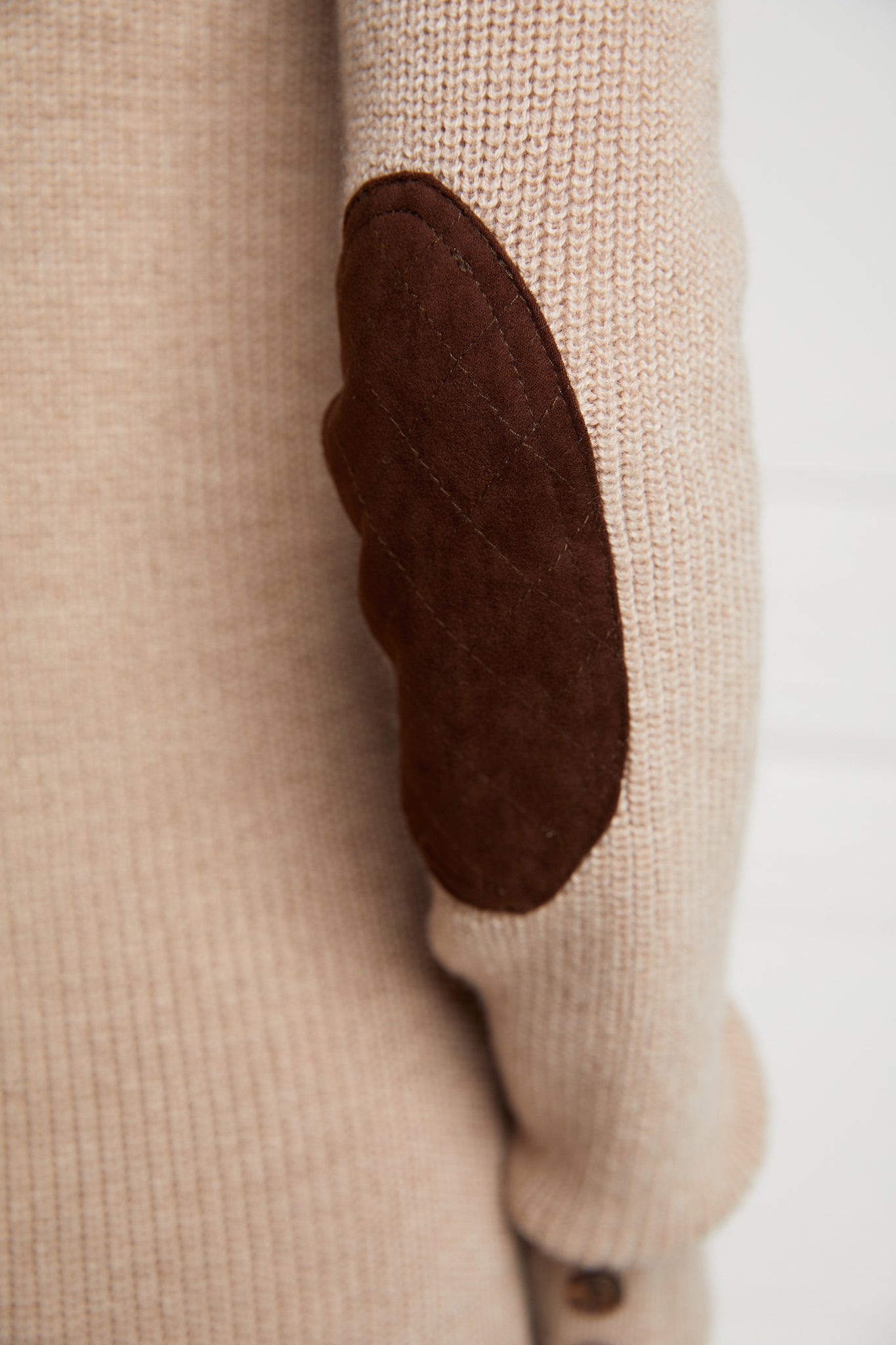 brown faux suede quilted elbow patch detail on classic crew neck slim fit merino wool jumper in taupe with gunpatch on shoulder in the same brown suede material