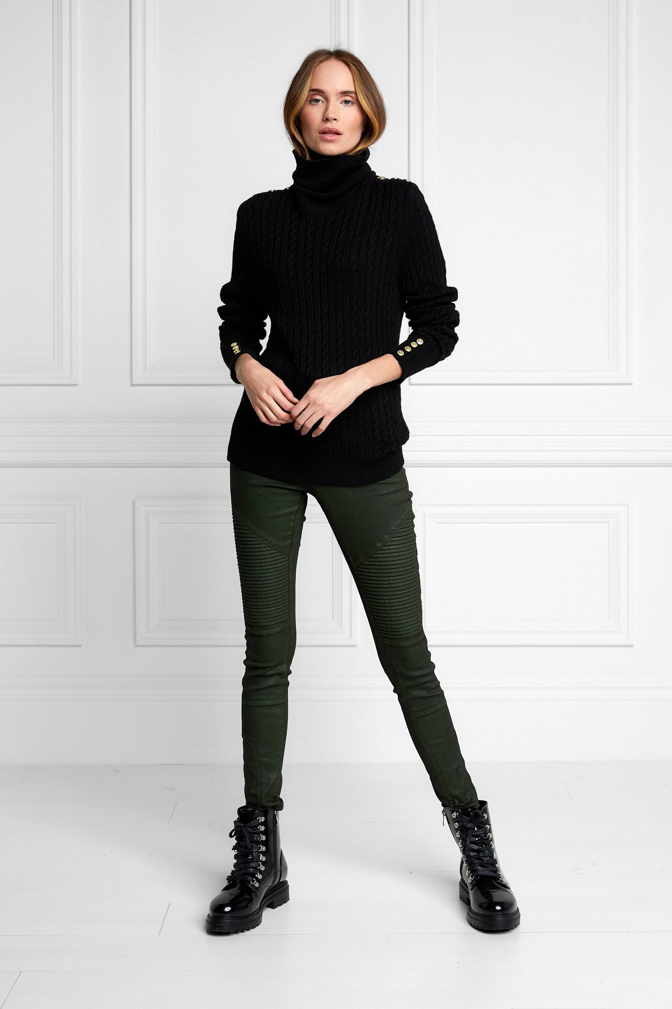 womens cable knit jumper in black with ribbed roll neck cuffs and hem